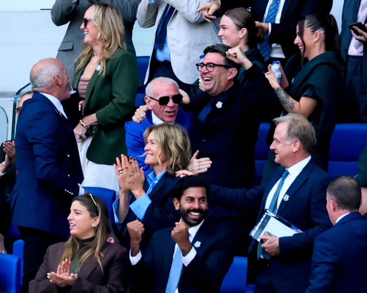 The UK Prime Minister, Andy Burnham (right) celebrates an Everton goal with the former Everton player Peter Reid (left).