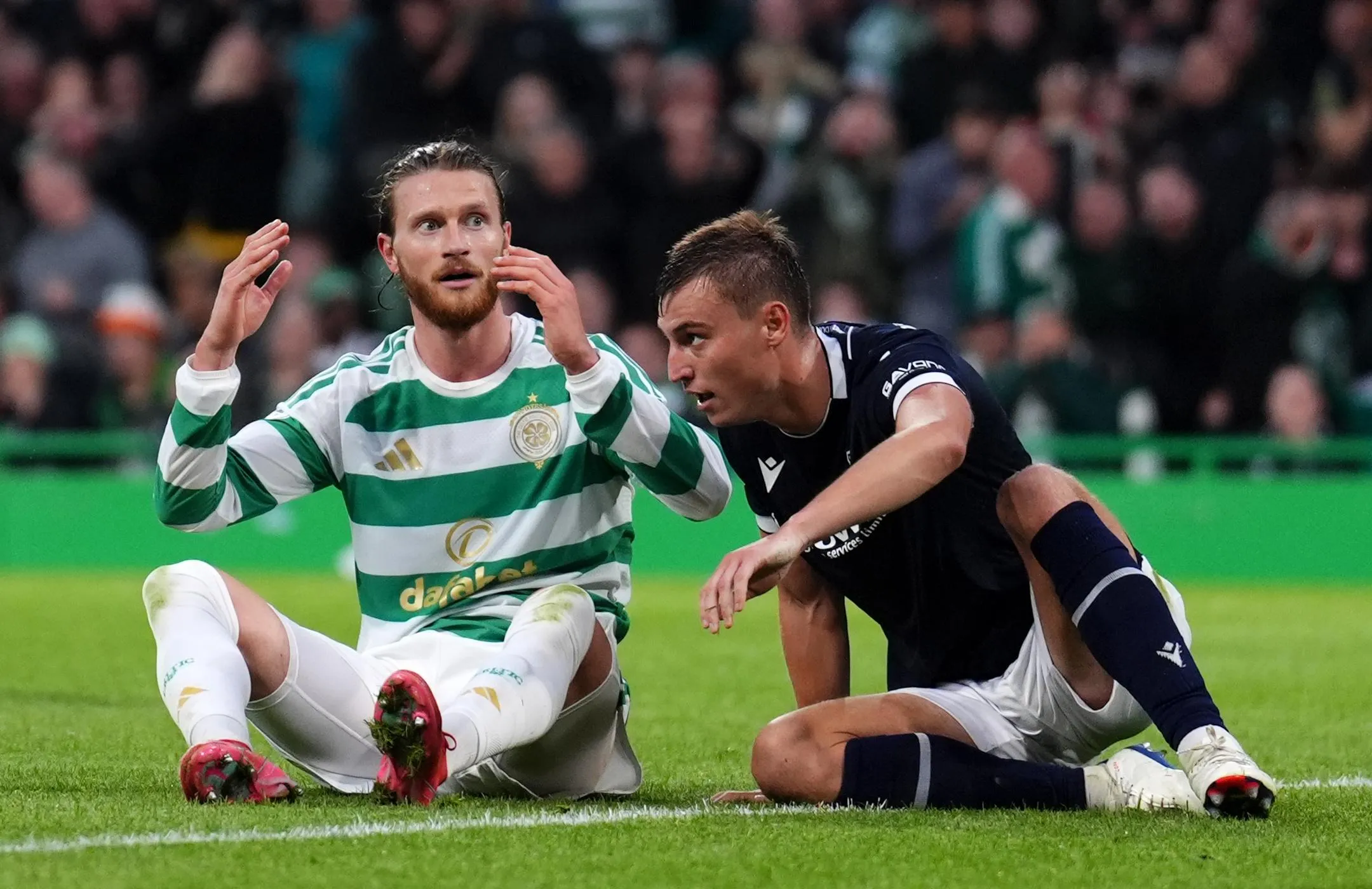 Celtic's Kasper Høgh (left) reacts after a missed chance against Dundee.