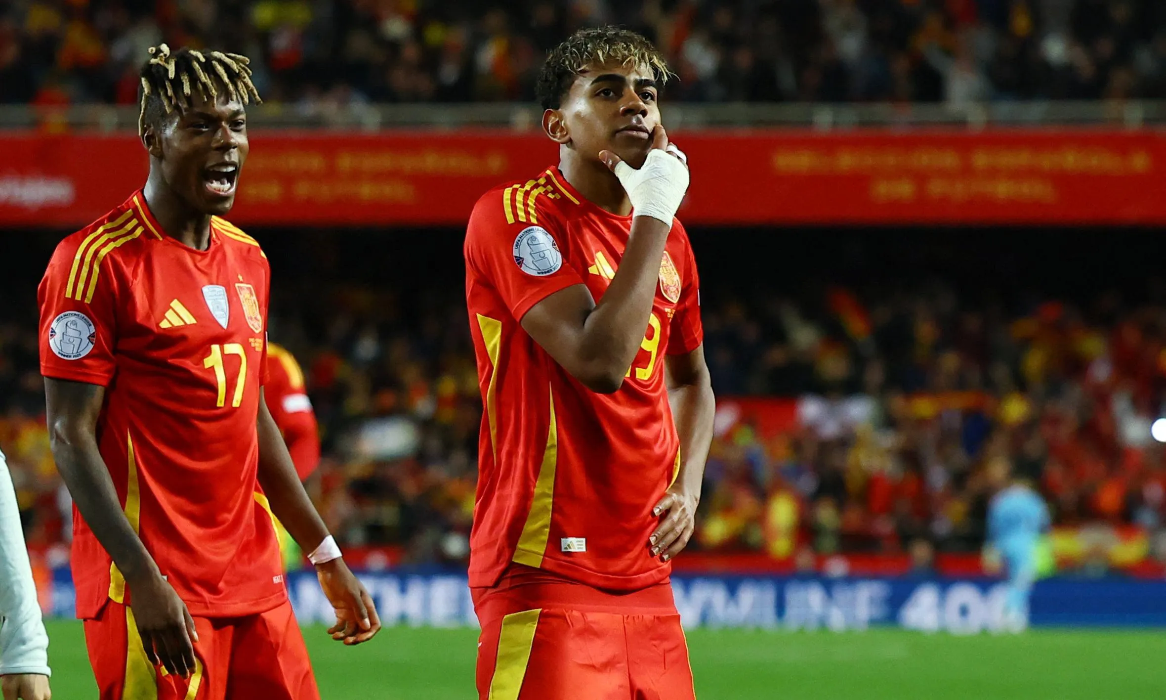 Spain's Lamine Yamal celebrates with Nico Williams after scoring their third goal.