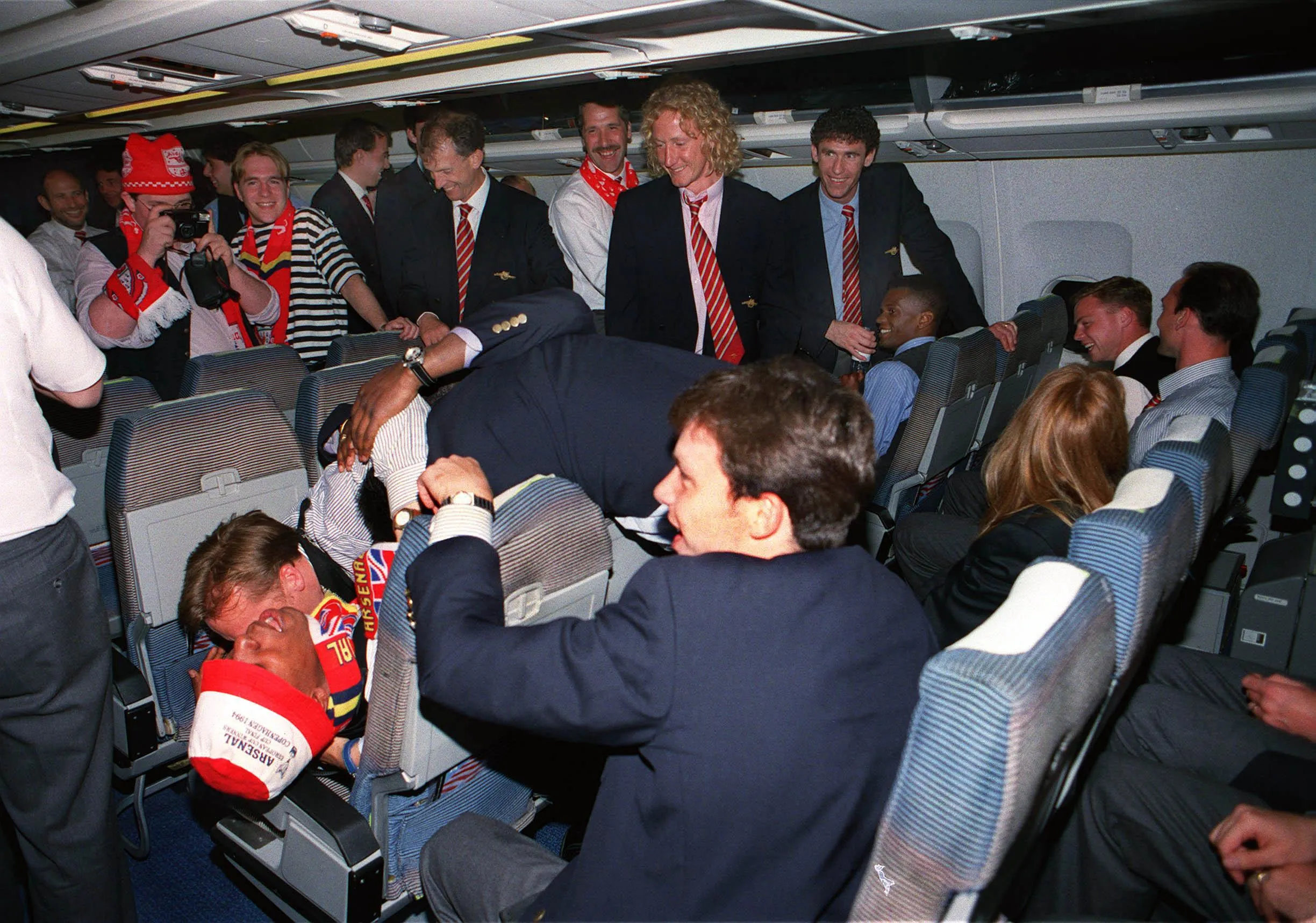 Lee Dixon and Ian Wright of Arsenal have a playful fight over the seats on the plane home from the Cup Winners’ Cup final.