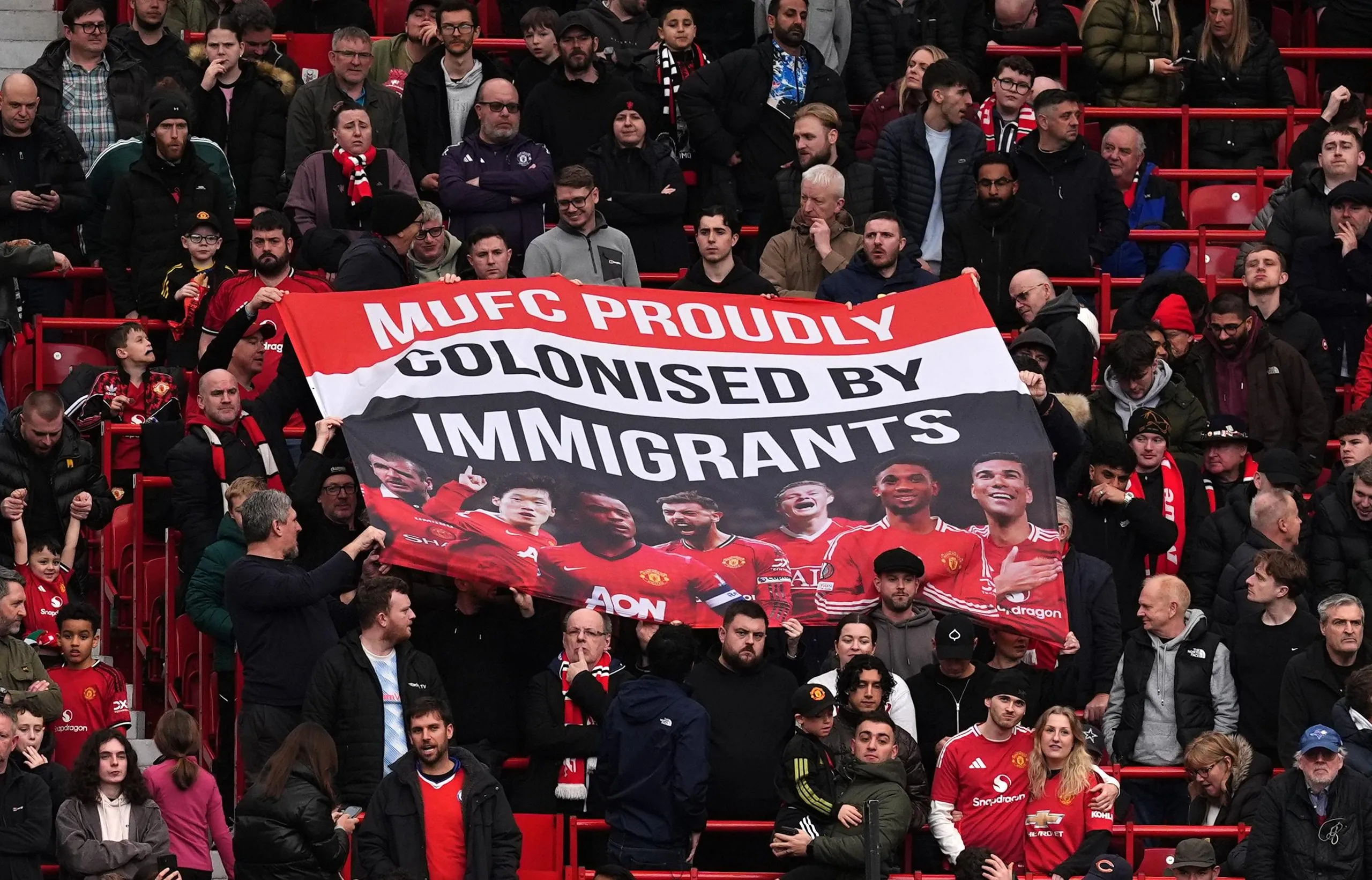 Manchester United fans display a banner