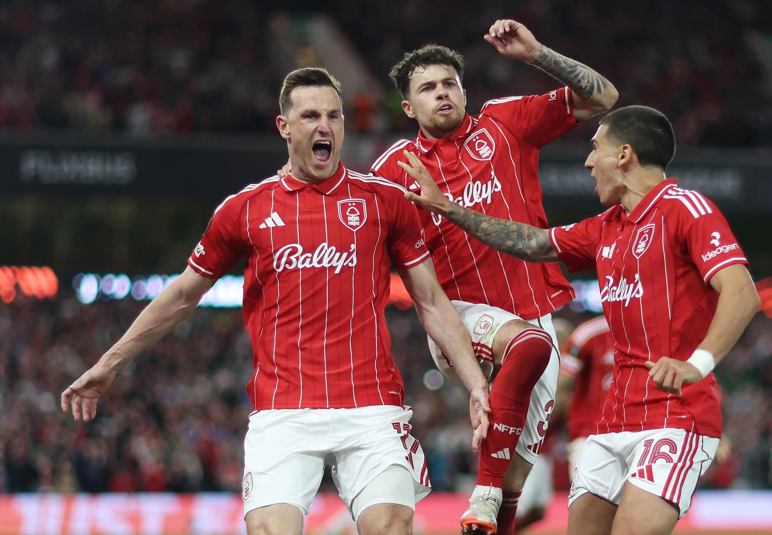 Chris Wood of Nottingham Forest celebrates scoring his team’s first goal from the penalty spot with Neco Williams and Nicolas Dominguez.