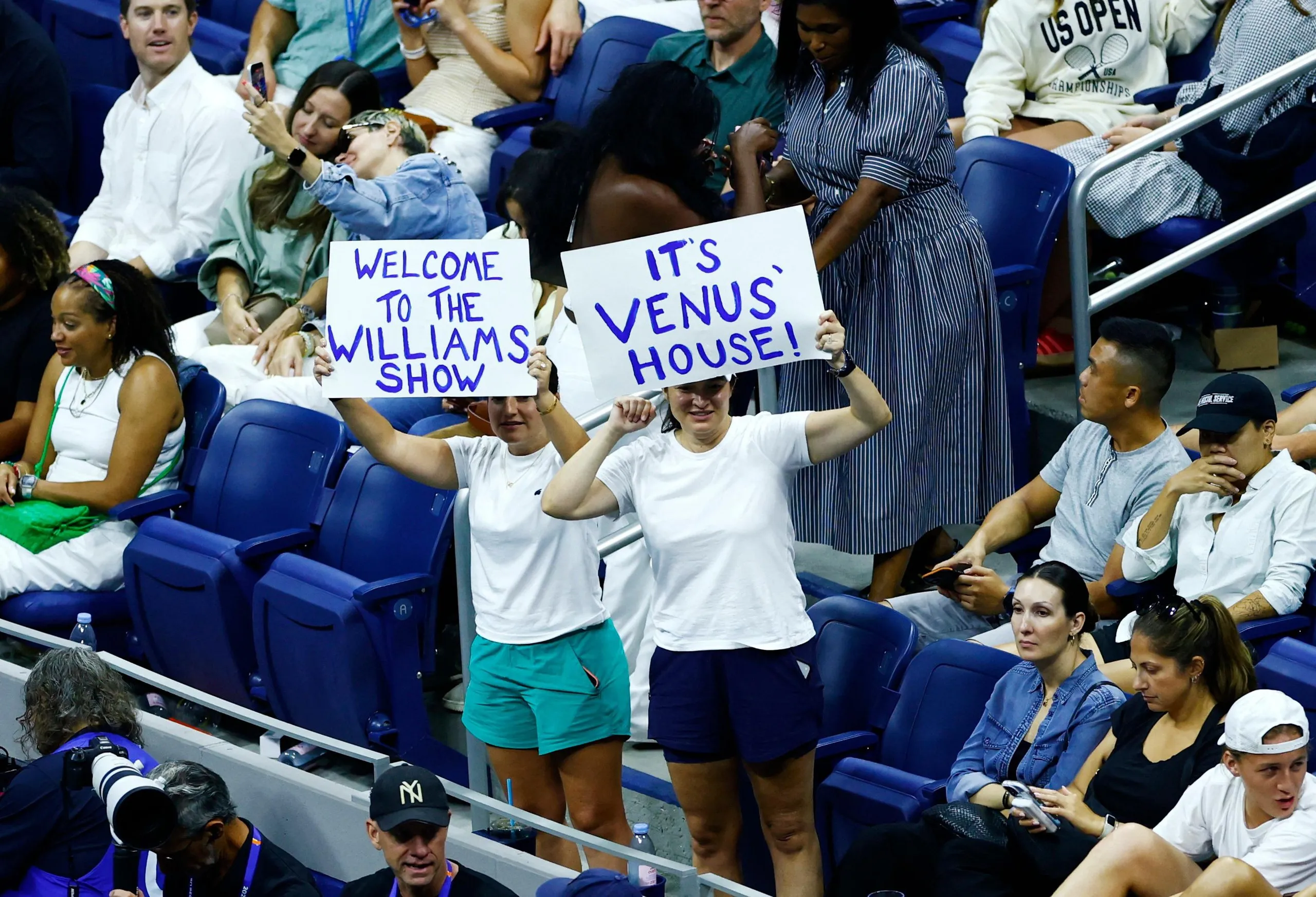 Fans of Venus Williams hold up signs during her first-round match against fellow American Sofia Kenin at the US Open early Monday morning in New York.