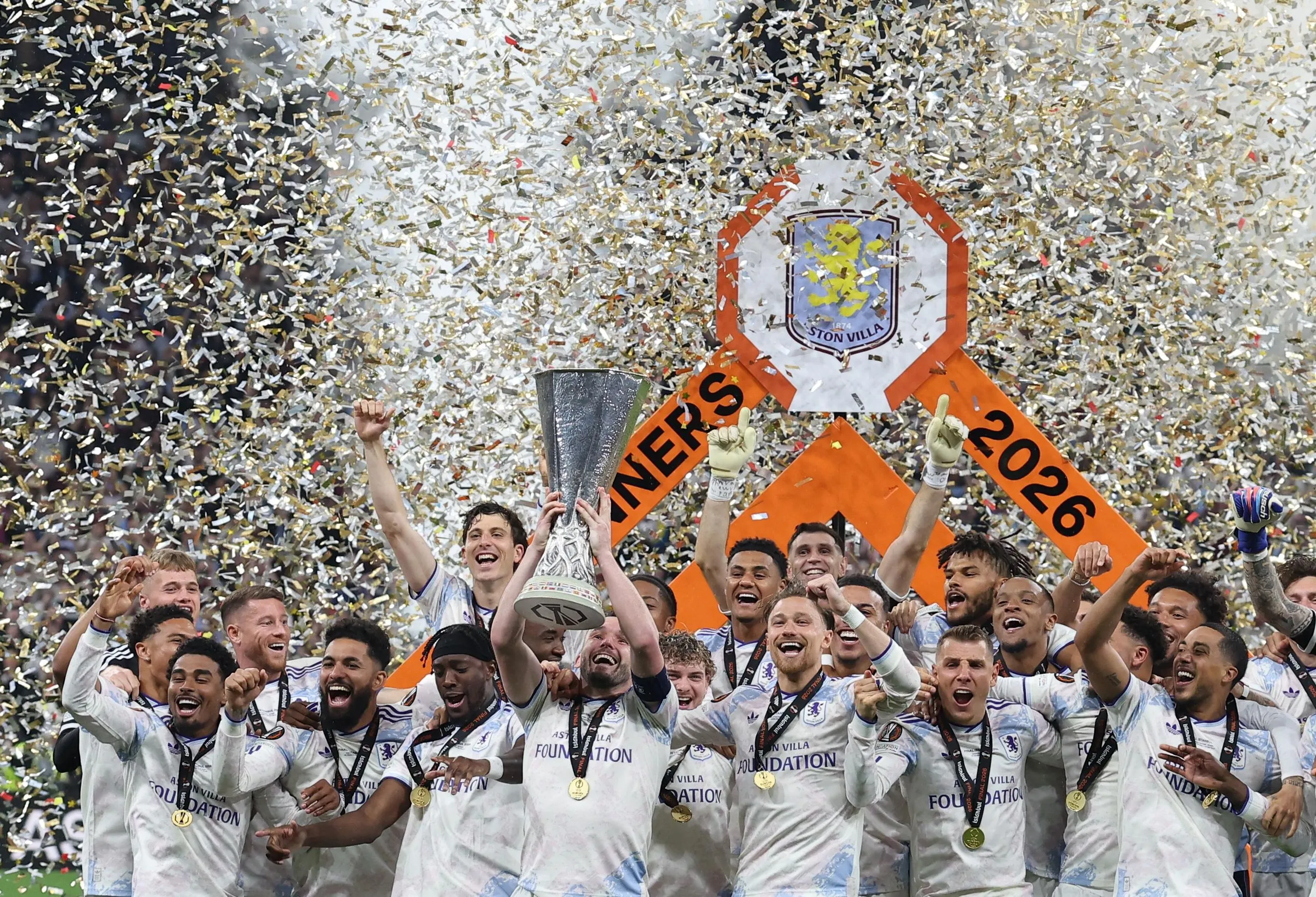 Aston Villa's John McGinn lifts the trophy as he celebrates with teammates after winning the UEFA Europa League