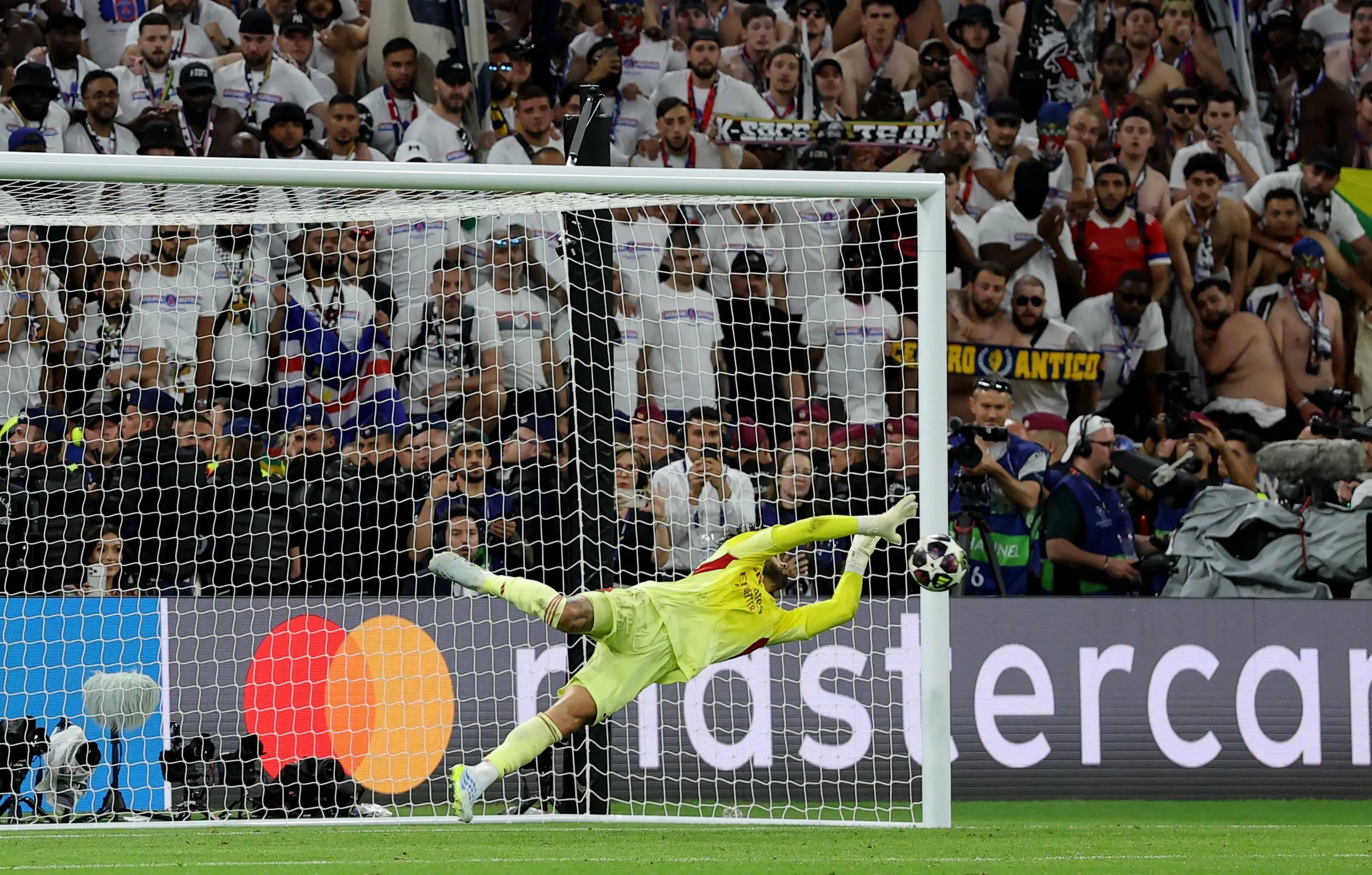 Arsenal's David Raya saves a penalty from Paris St Germain's Nuno Mendes during the penalty shoot-out.