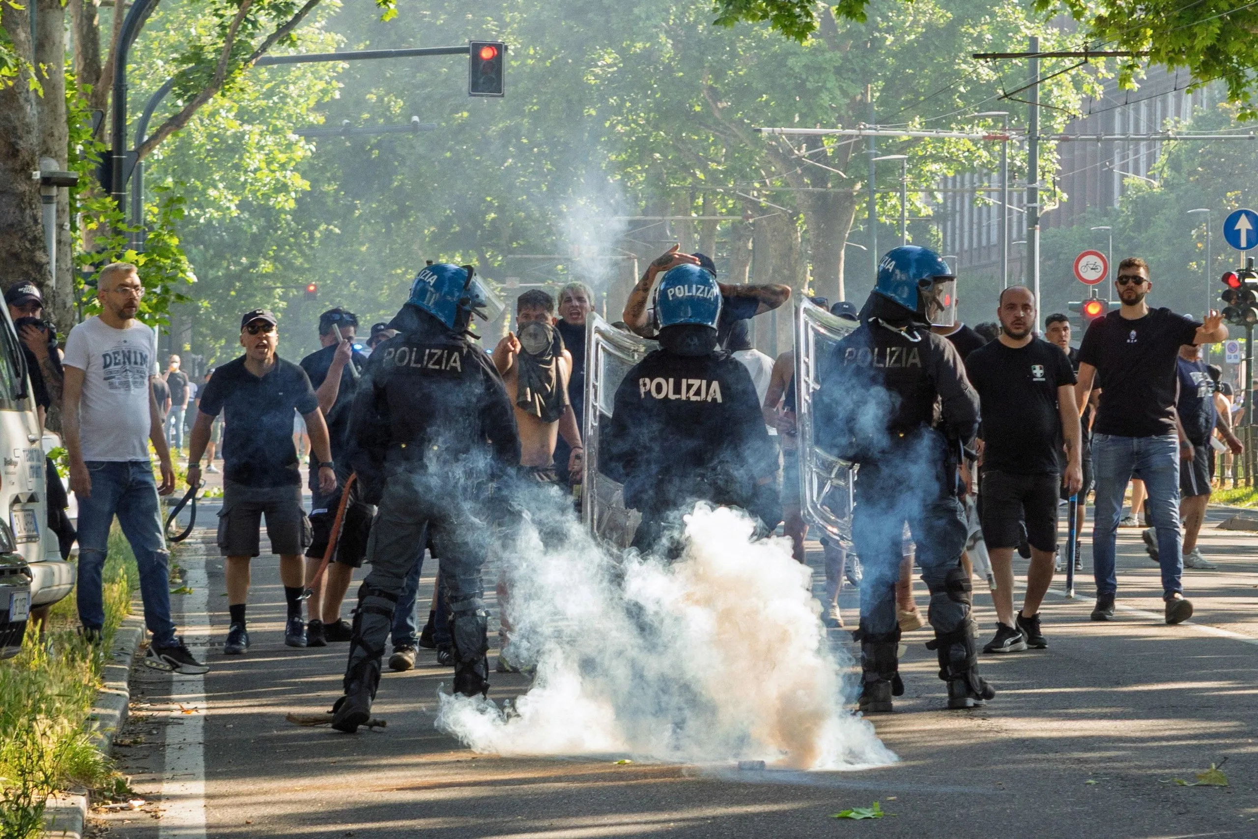 Fans clash outside the stadium as the police look on before Torino v Juventus