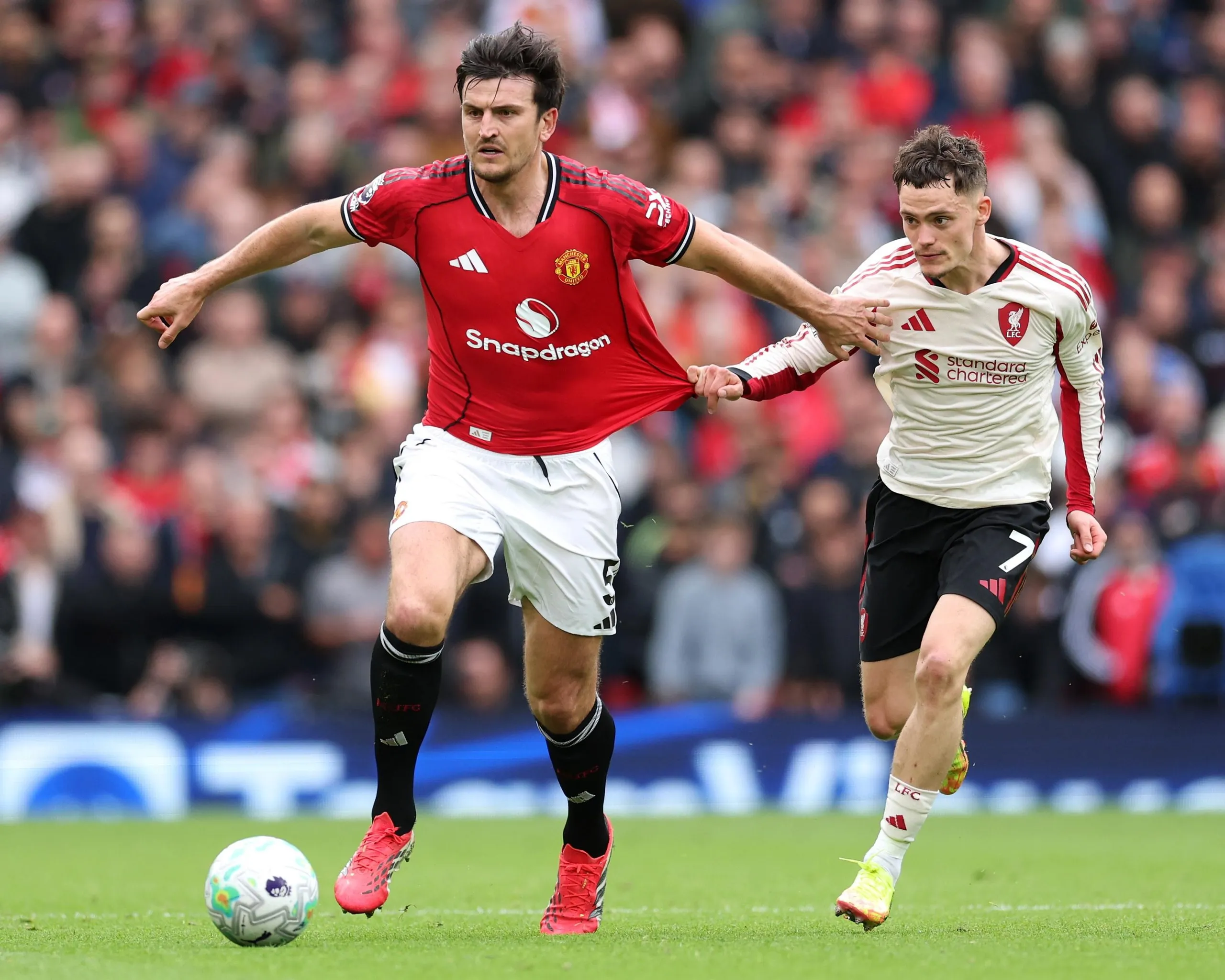 Harry Maguire fends off Florian Wirtz