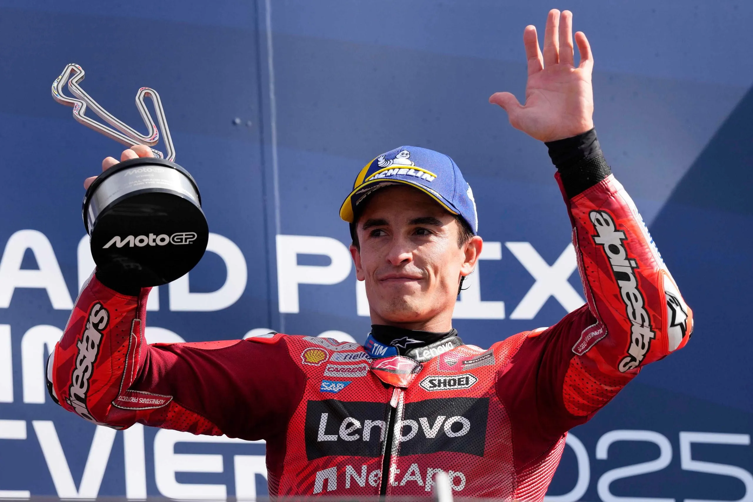 Marc Márquez acknowledges the spectators from the podium after winning the San Marino Grand Prix.