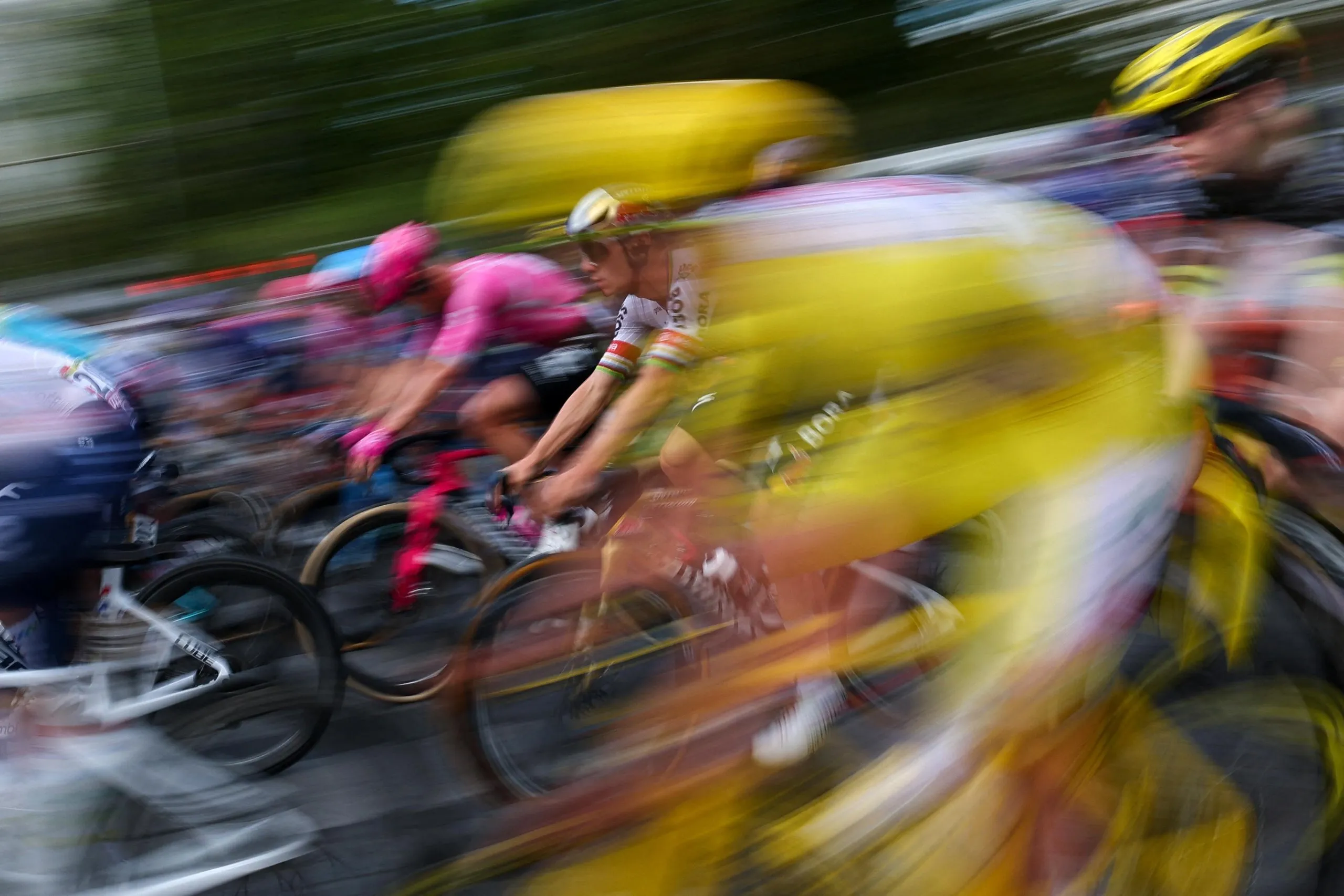 Remco Evenepoel (C) cycles with the pack.