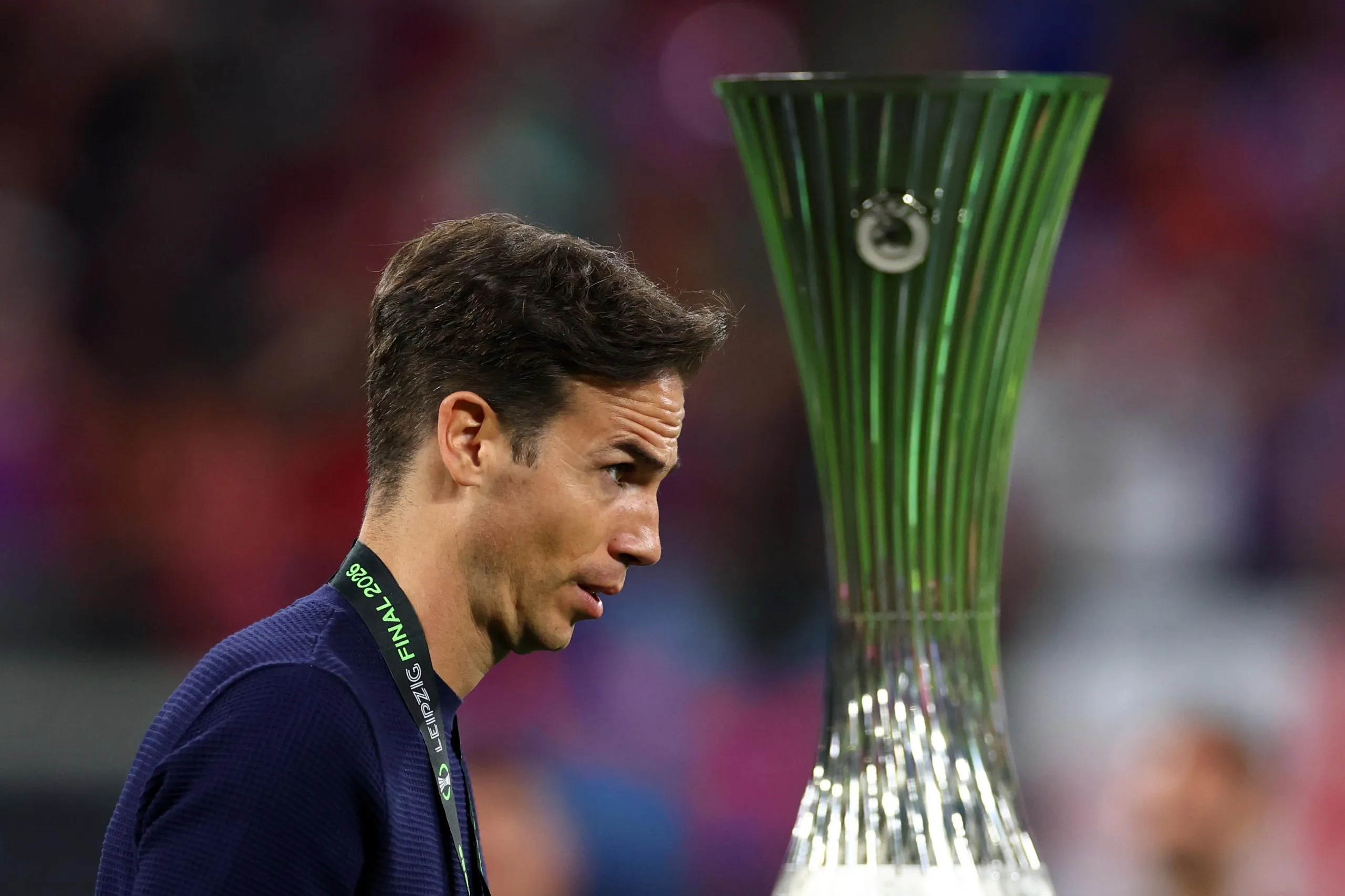 Rayo Vallecano manager Iñigo Pérez walks past the trophy at the end of the Conference League final