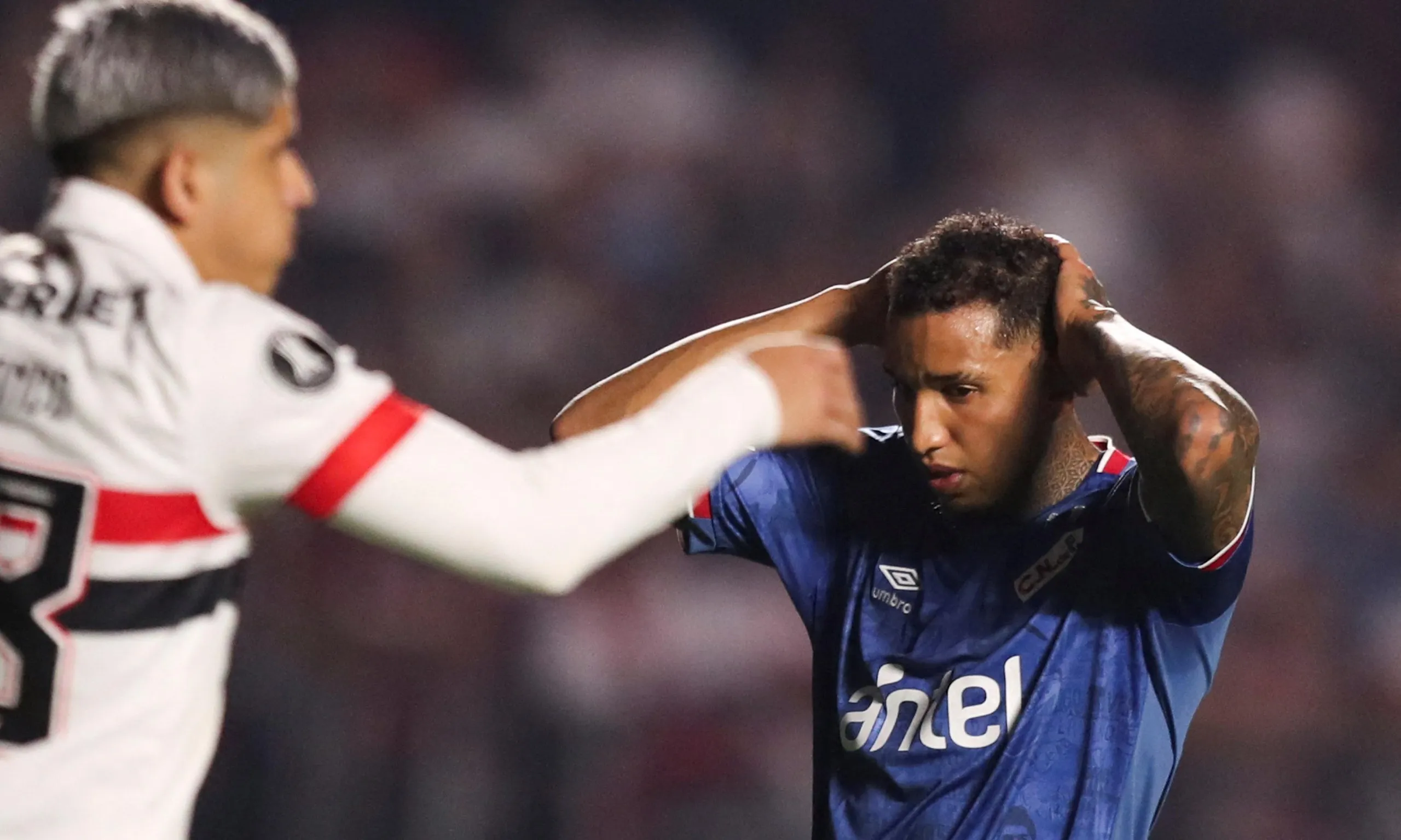 Nacional defender Juan Izquierdo (right) during the Copa Libertadores match against Sāo Paulo before he later collapsed.