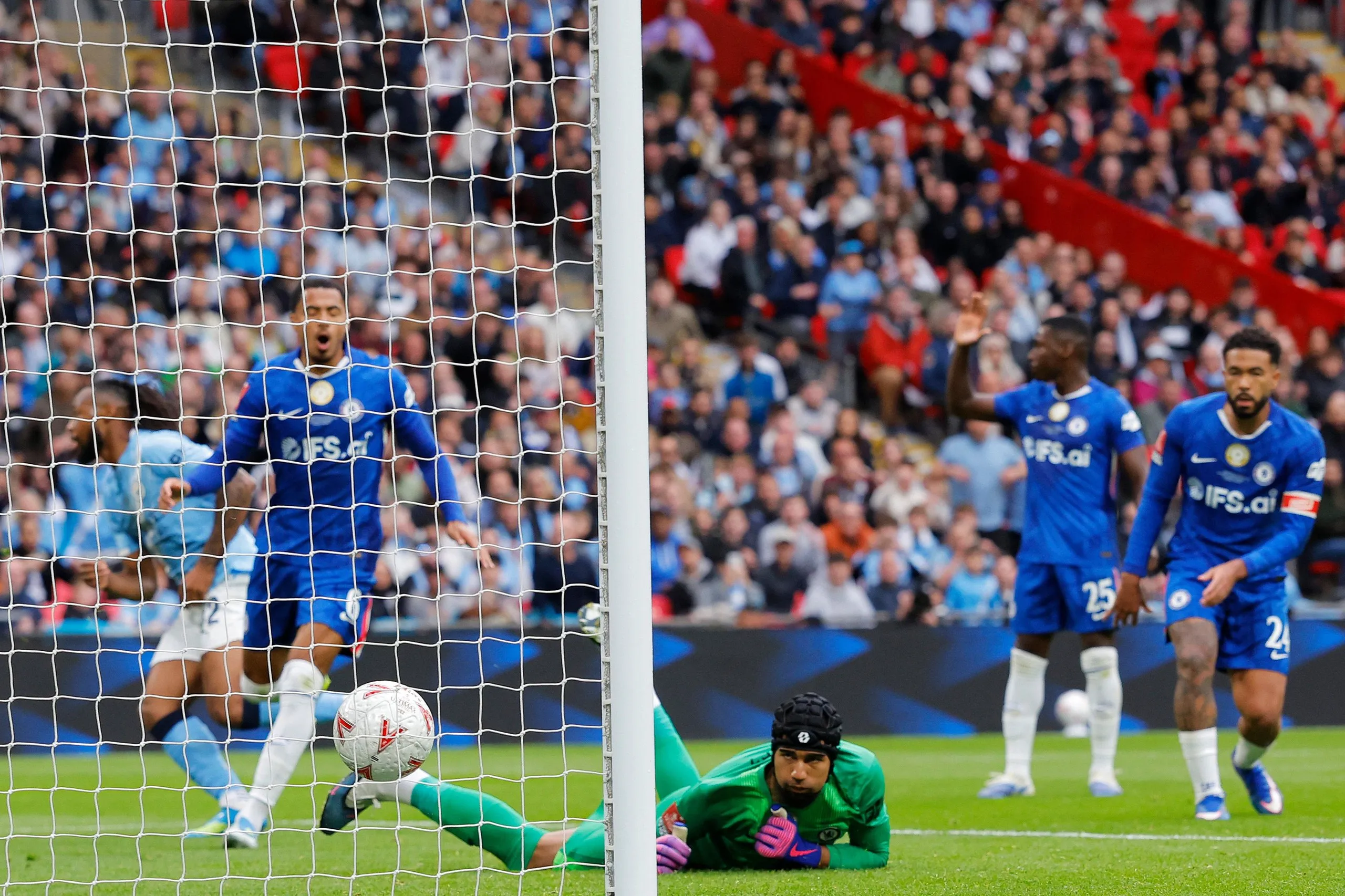 Chelsea keeper Robert Sanchez watches as a backheel from Antoine Semenyo of Manchester City goes past him and into the net to open the scoring.