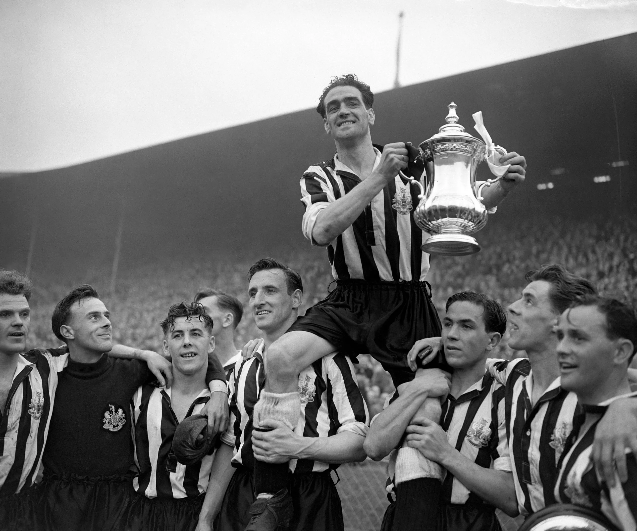Newcastle captain Joe Harvey holds aloft the trophy after the 1952 final