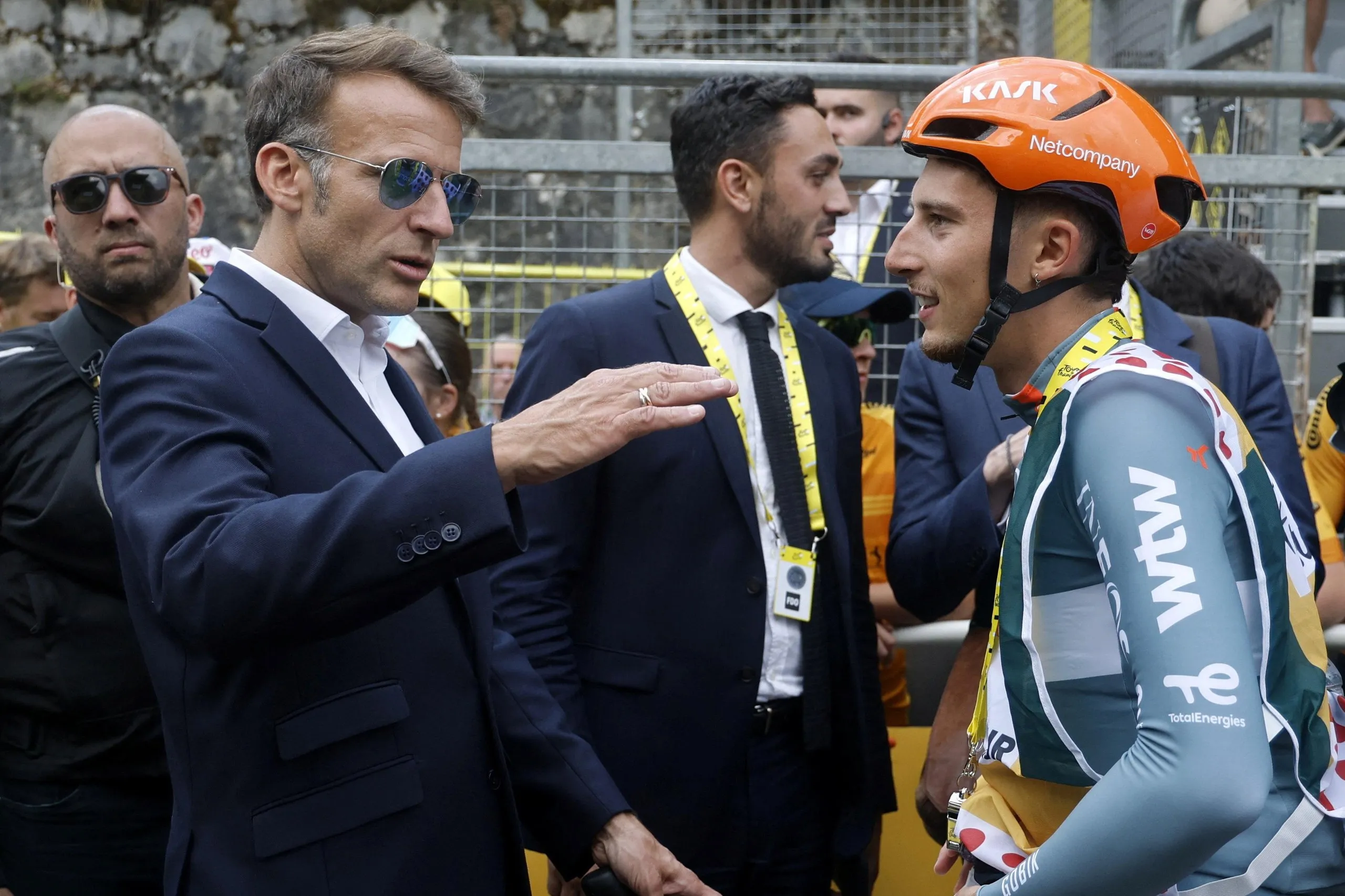 Emmanuel Macron, France’s president, speaking to Ineos’s French cyclist Kevin Vauquelin after stage six of the Tour de France