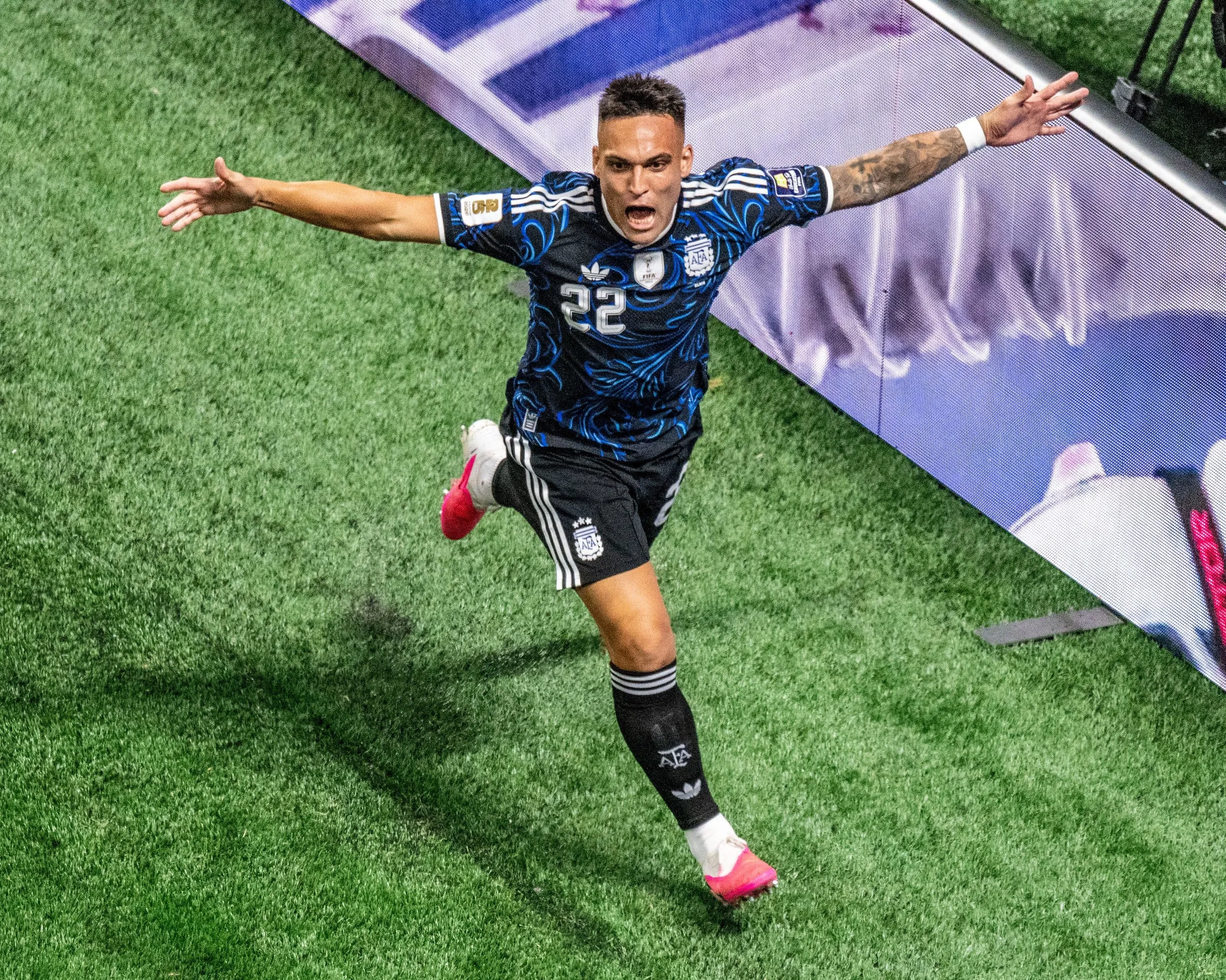 Lautaro Martínez spreads his arms in celebration after scoring his late winner for Argentina in the World Cup semi-final against England.