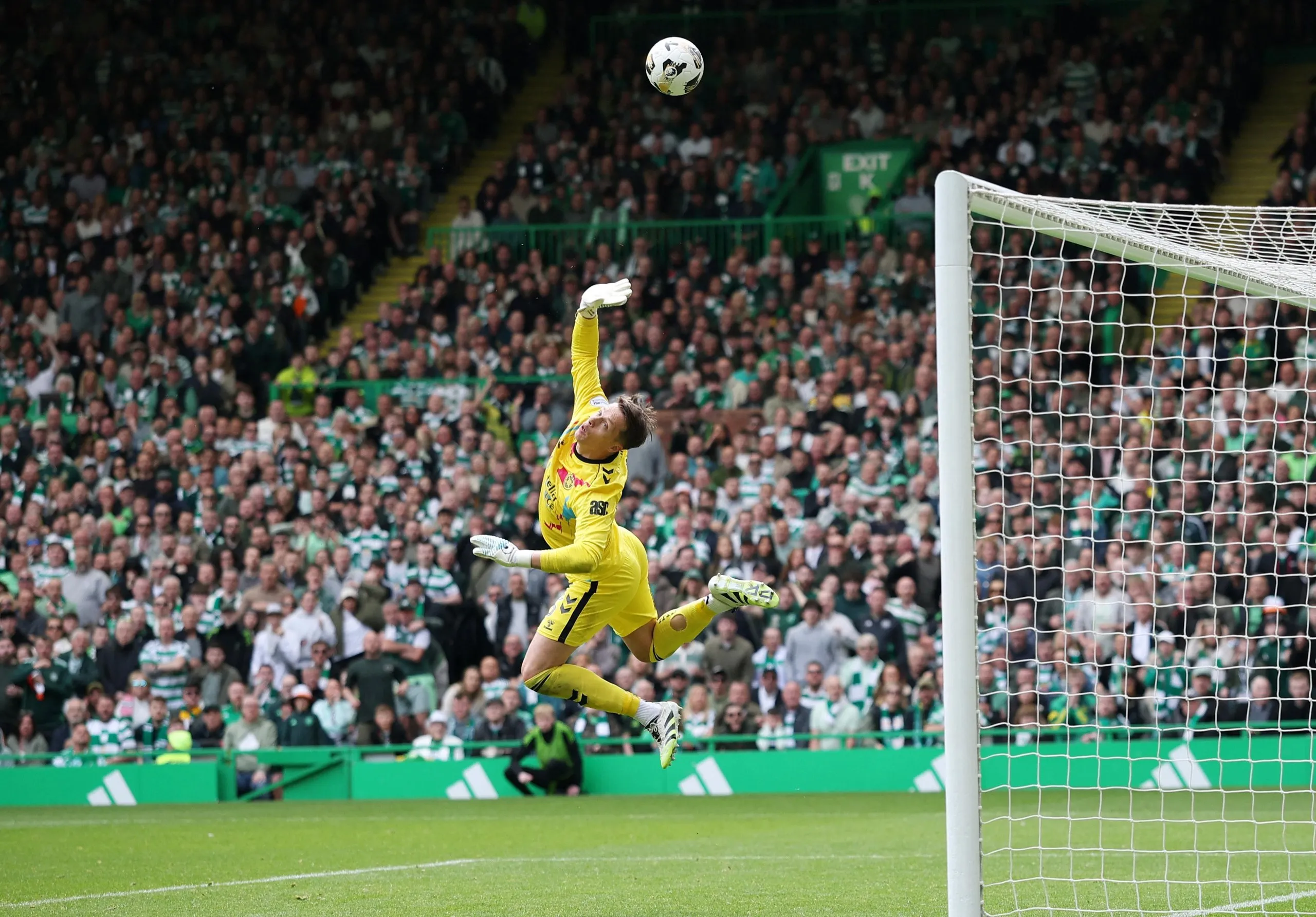 Heart of Midlothian's Alexander Schwolow saves a shot from Celtic's Benjamin Nygren.