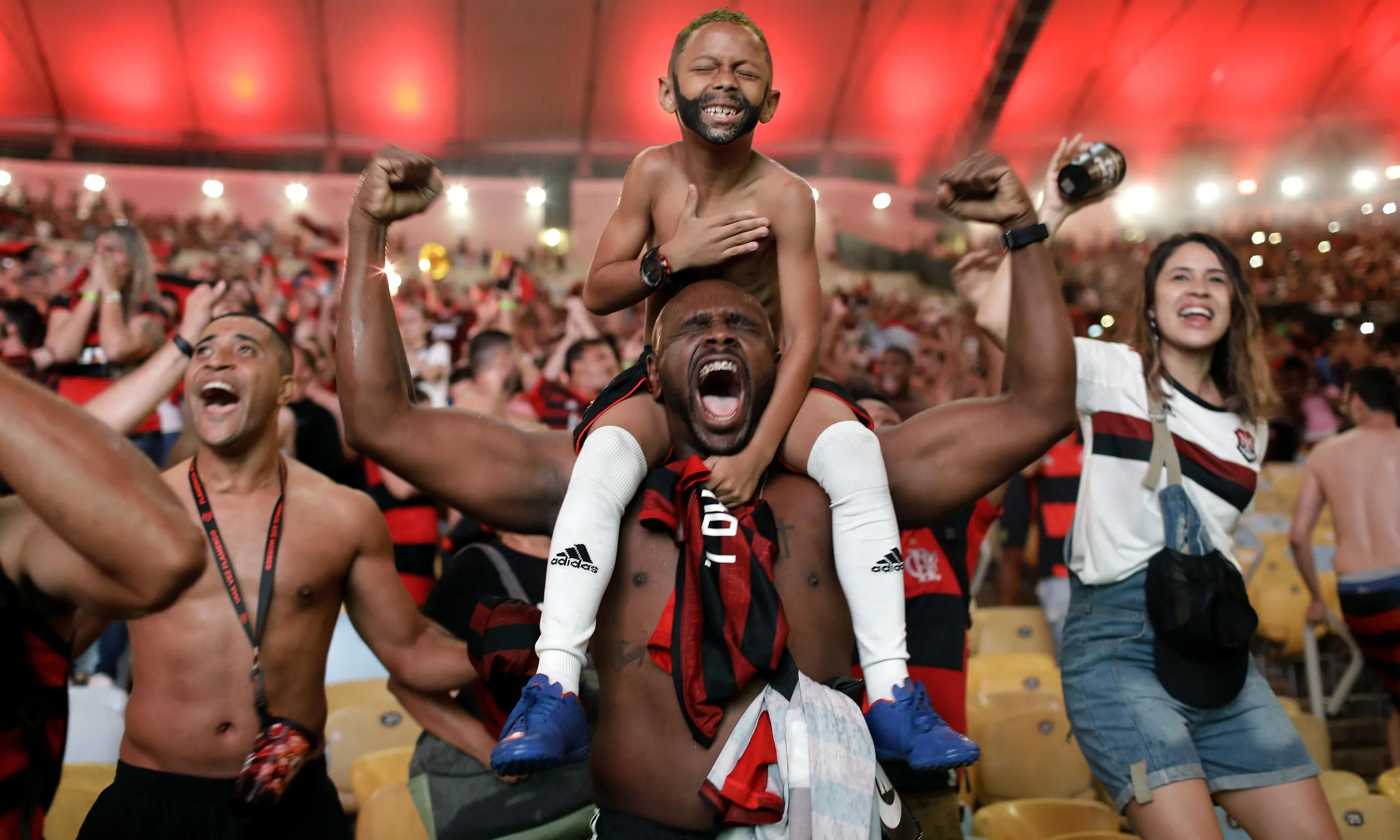 Flamengo fans watching the match on a giant screen at the Macarena Stadium, in Rio de Janeiro, celebrate after Gabriel Barbosa scores.