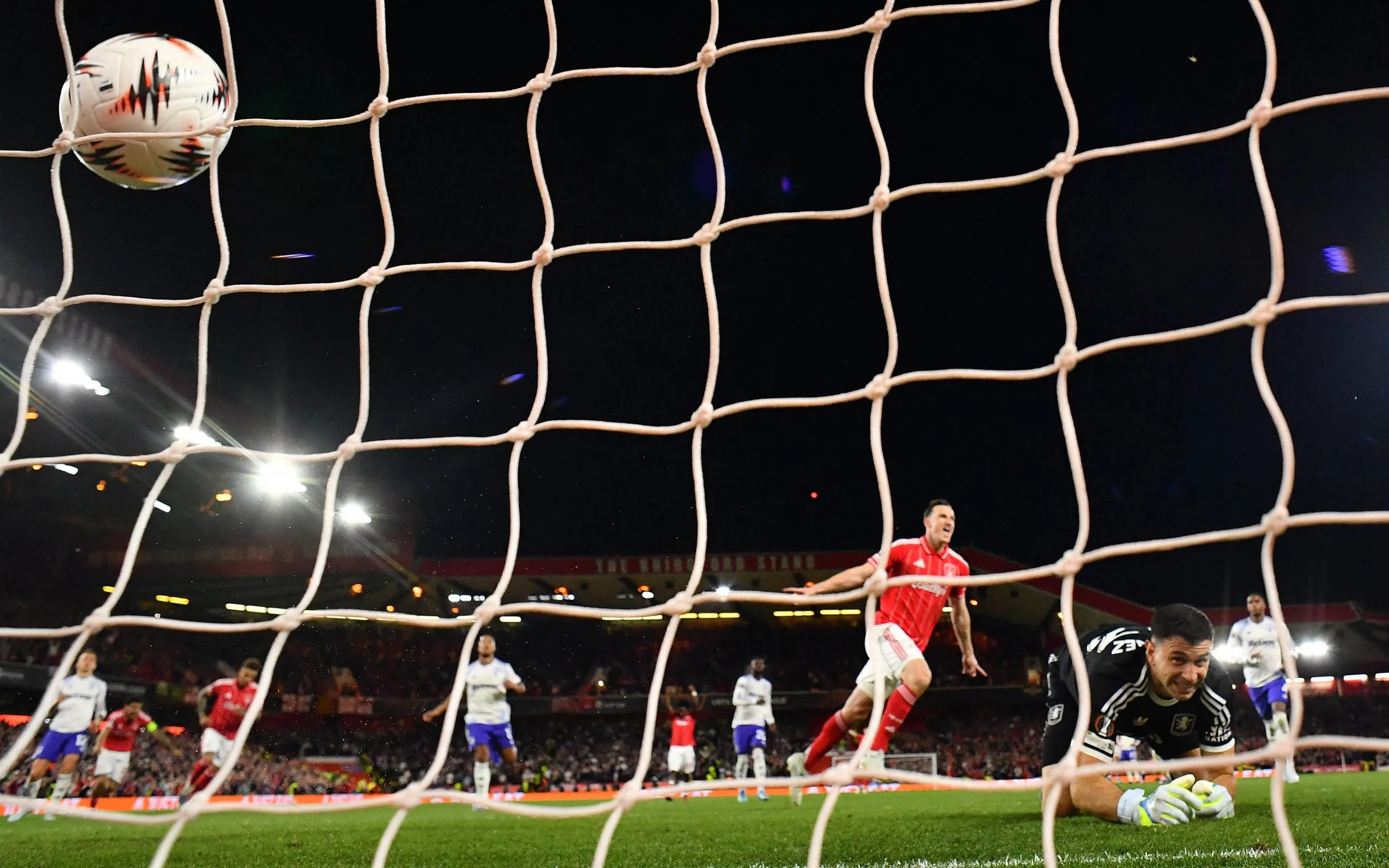 Nottingham Forest's Chris Wood celebrates scoring their first goal past Aston Villa's keeper Emiliano Martinez from the penalty spot.
