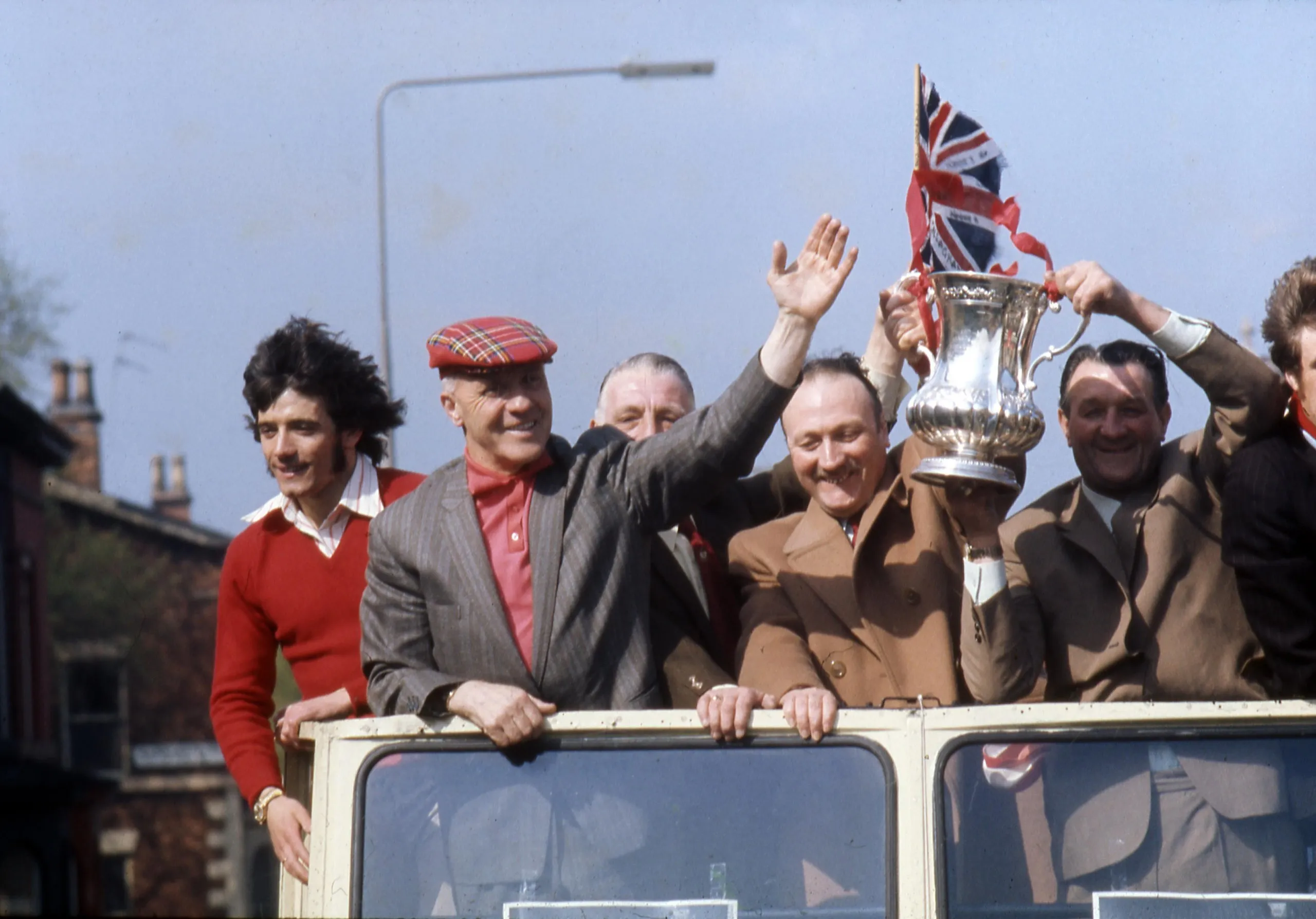 Kevin Keegan, Bill Shankly, chairman Sir John Smith and Bob Paisley on an open-top bus parade with the trophy after Liverpool’s win in 1974