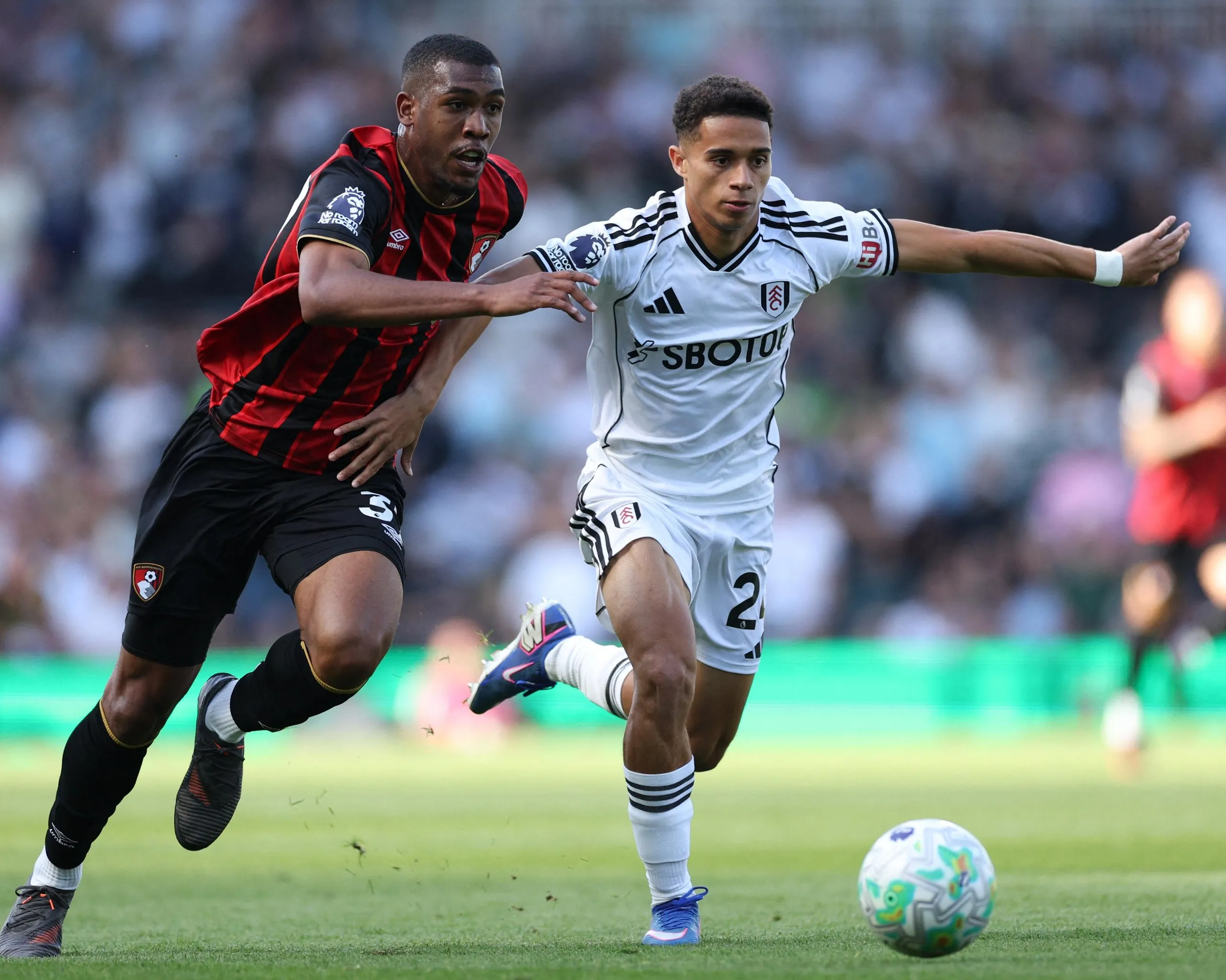 Josh King on the ball with Bournemouth’s Rayan in pursuit