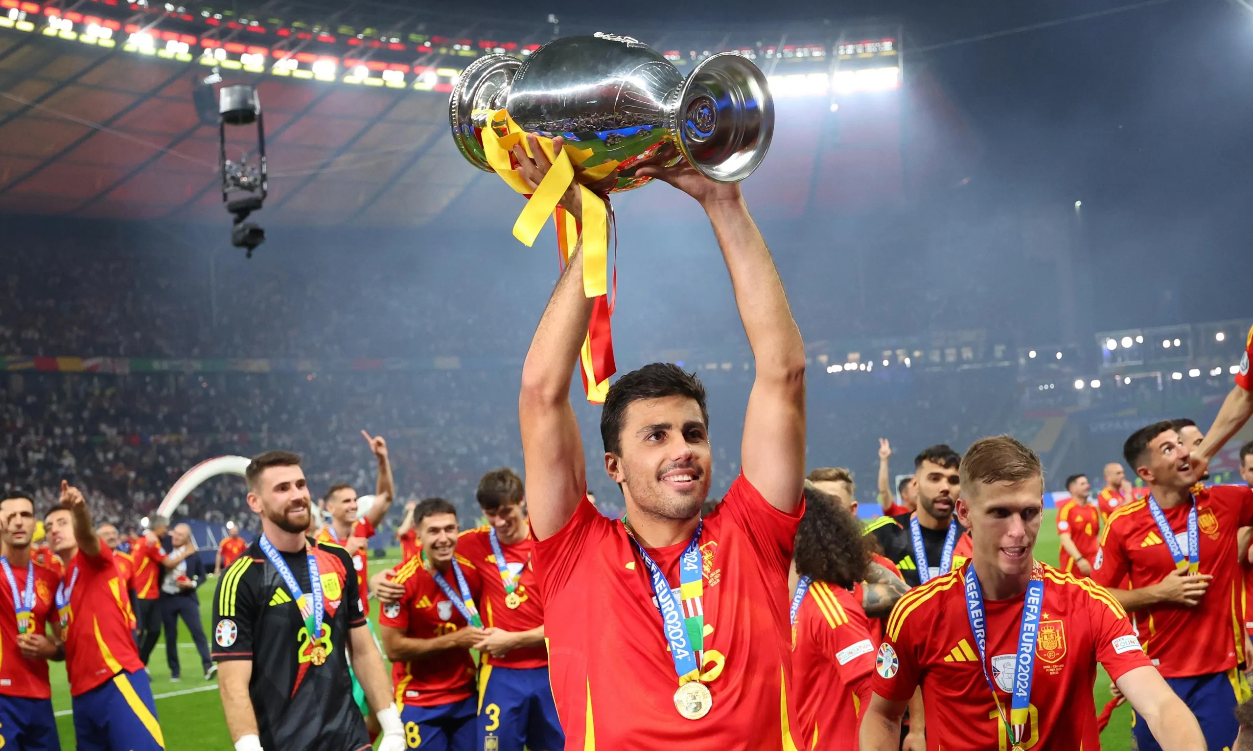Rodri lifts the European Championship trophy in celebration after Spain’s victory in the final.