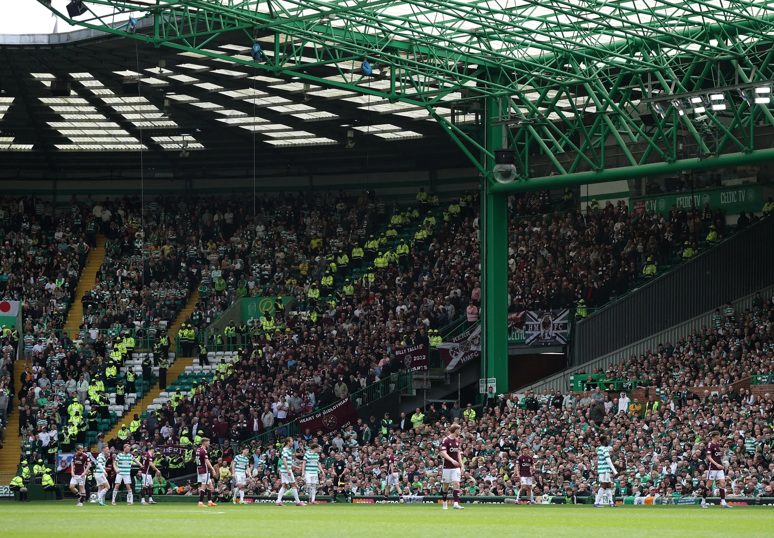 The Hearts fans cheer on their side.