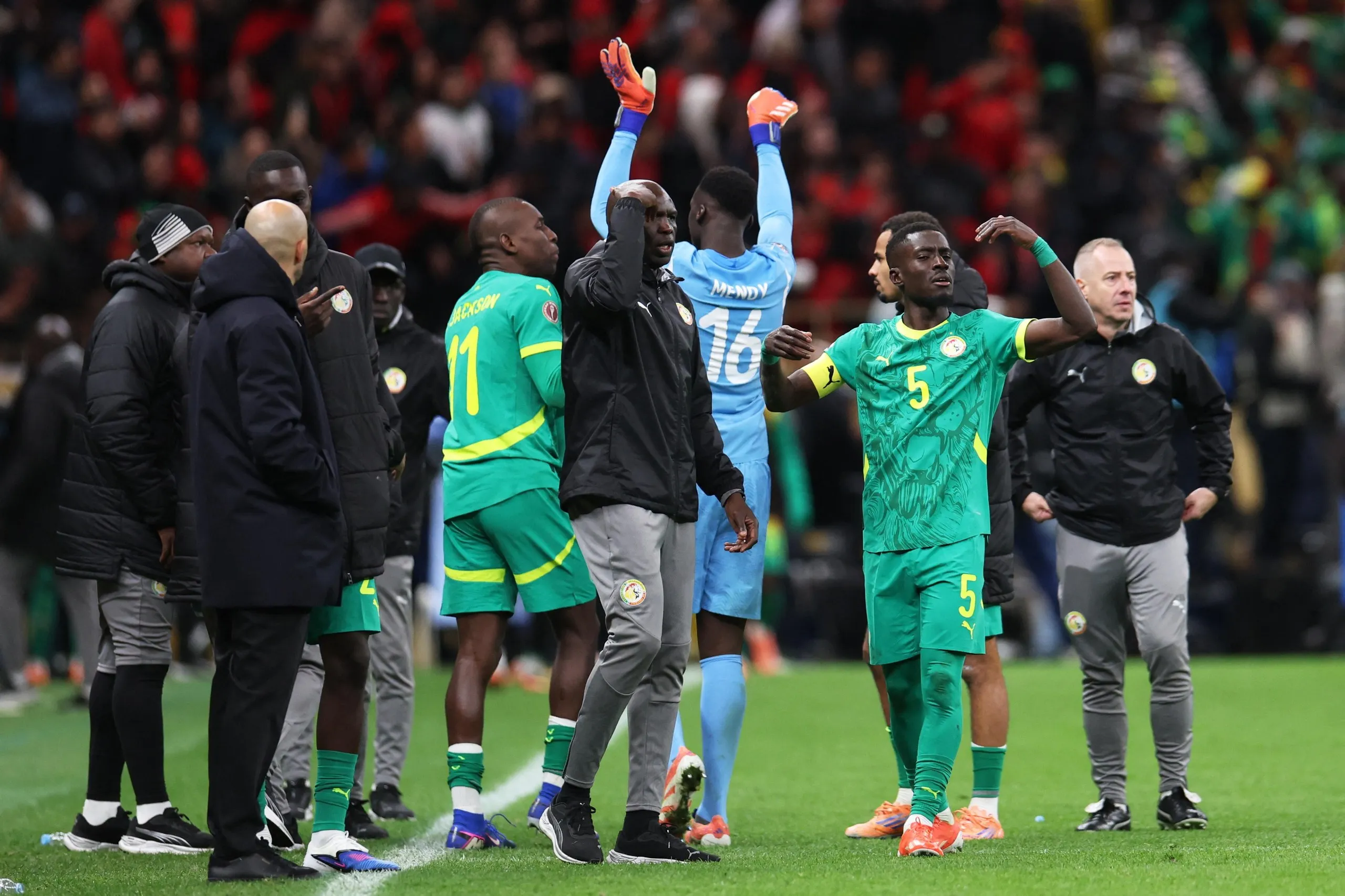 Senegal’s Idrissa Gueye gestures to his teammates to leave the pitch after a penalty is awarded to Morocco in the Afcon final.