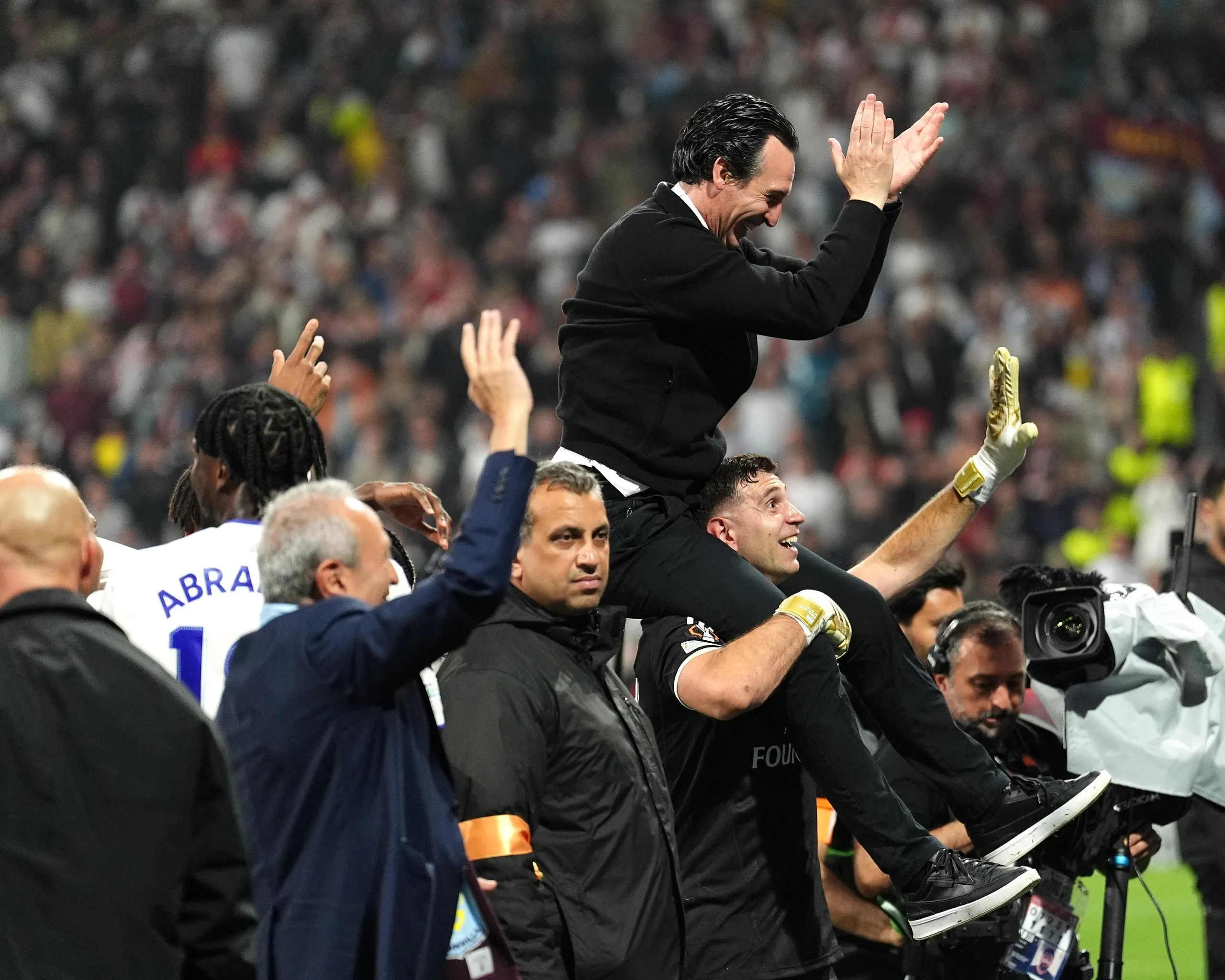 Emiliano Martínez carries Unai Emery on his shoulders after the final whistle.