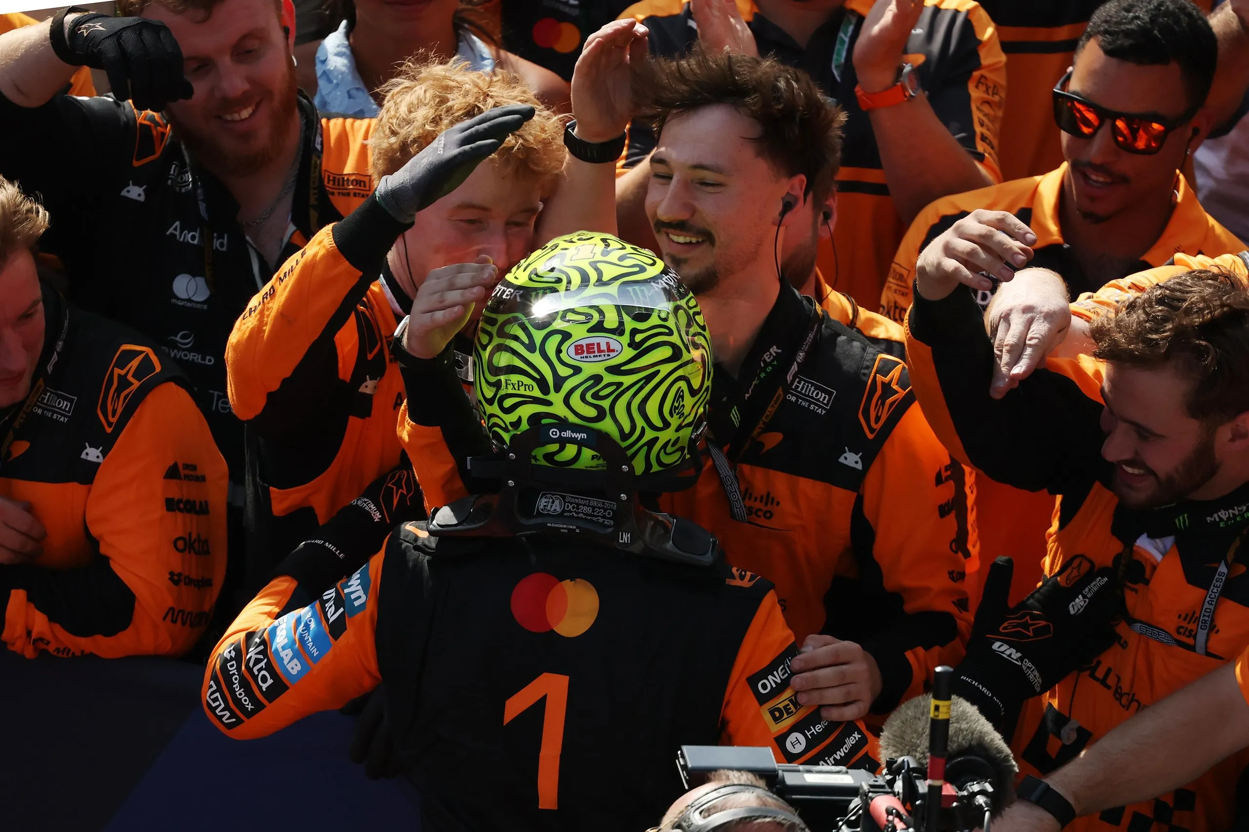 Race winner Lando Norris celebrates with his team in parc ferme.
