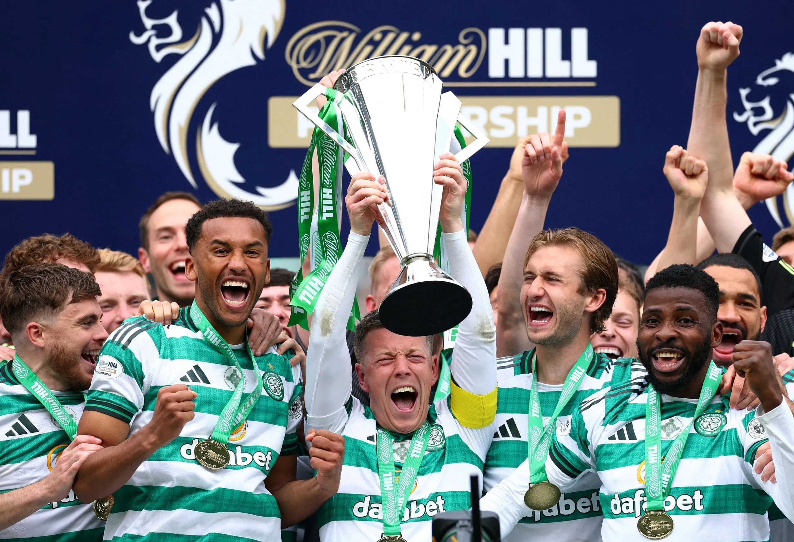 Celtic players lift the Scottish Premiership trophy after their title win.