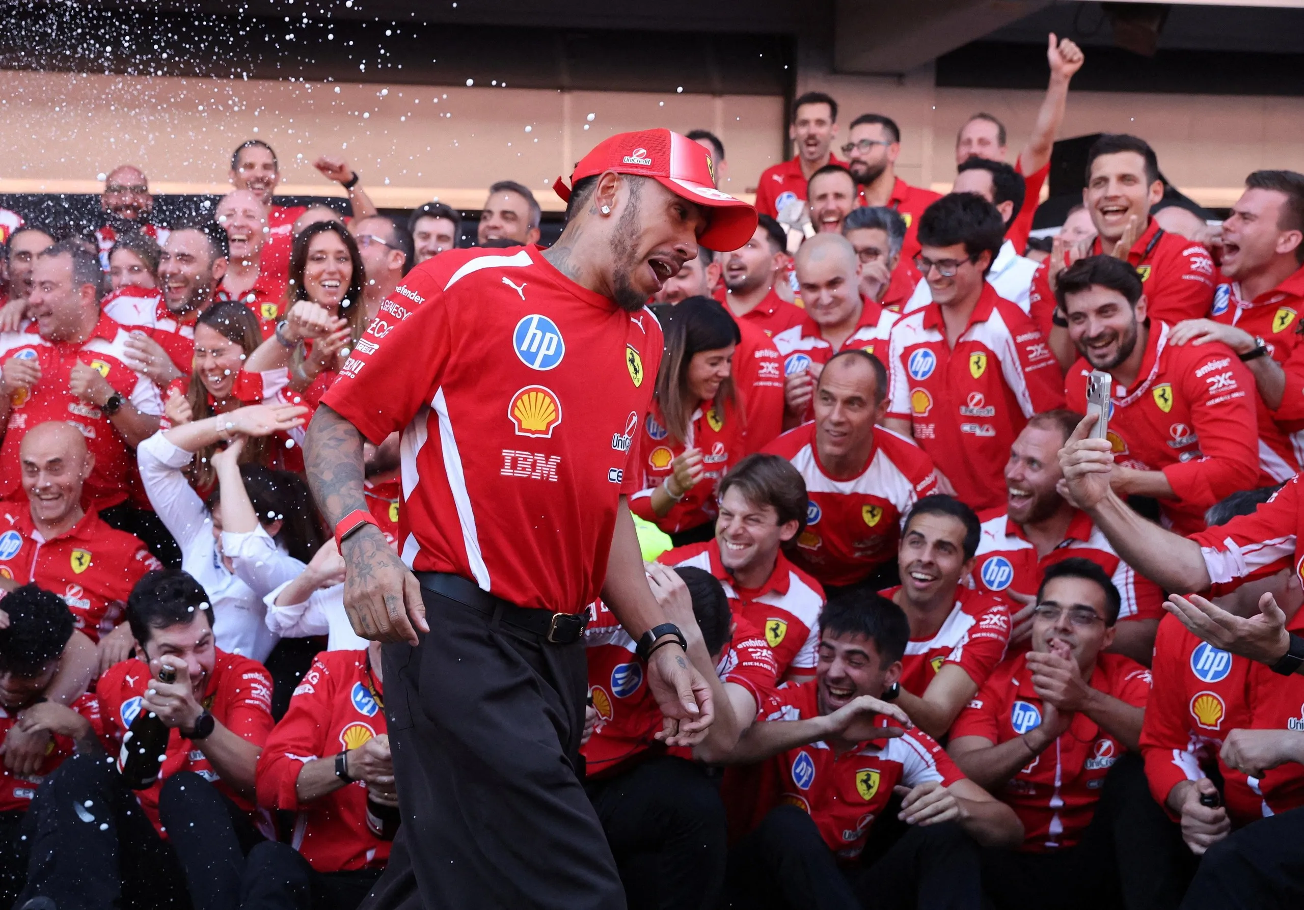 Lewis Hamilton celebrates with the Ferrari team after winning the Spanish Grand Prix
