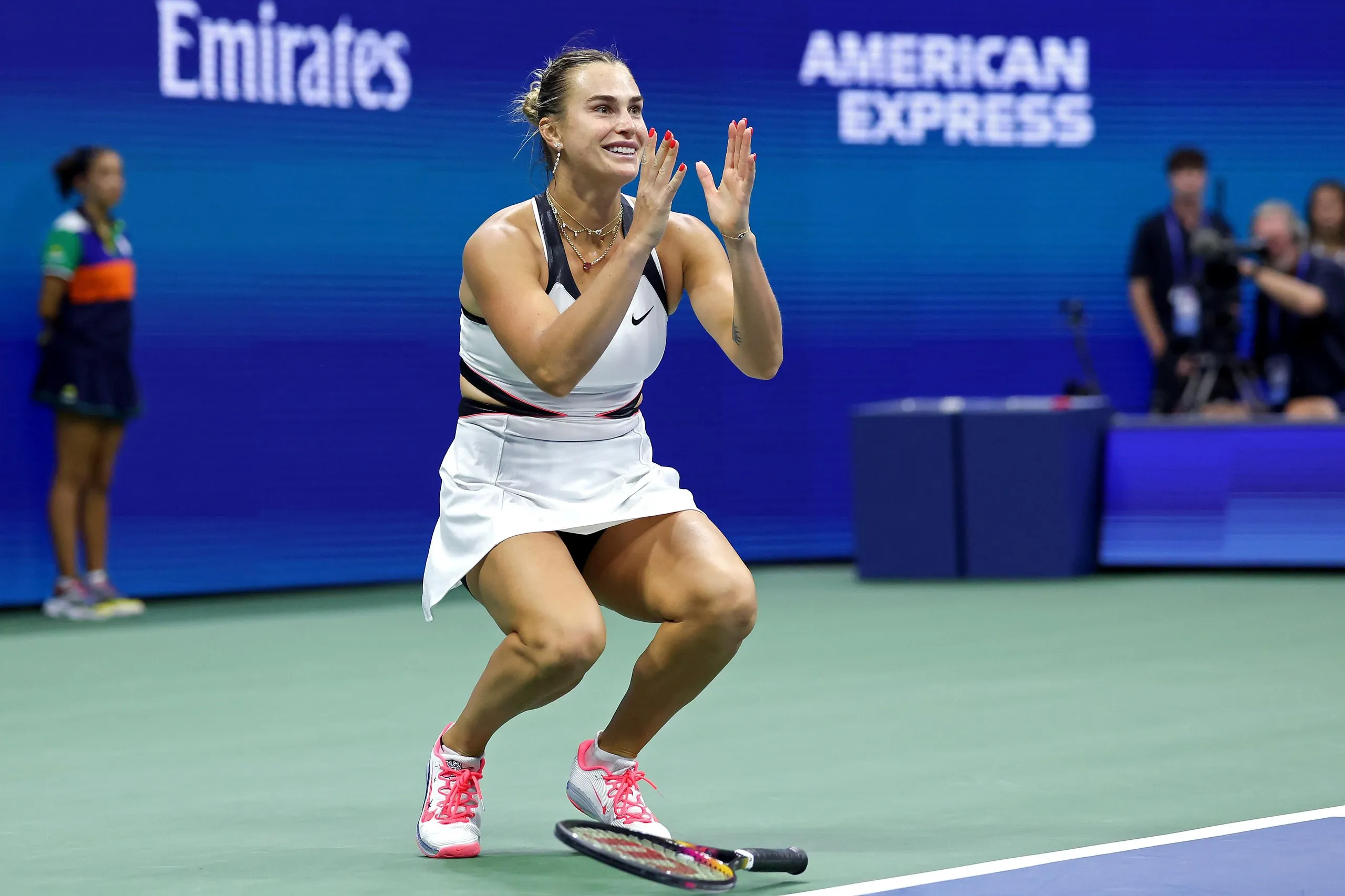 Aryna Sabalenka drops her racket in delight after winning the final