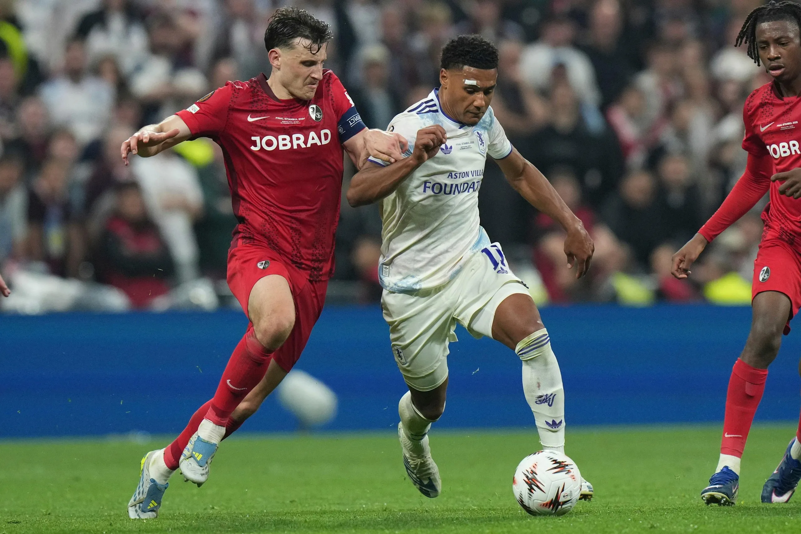 Maximilian Eggestein and Ollie Watkins fight for the ball.