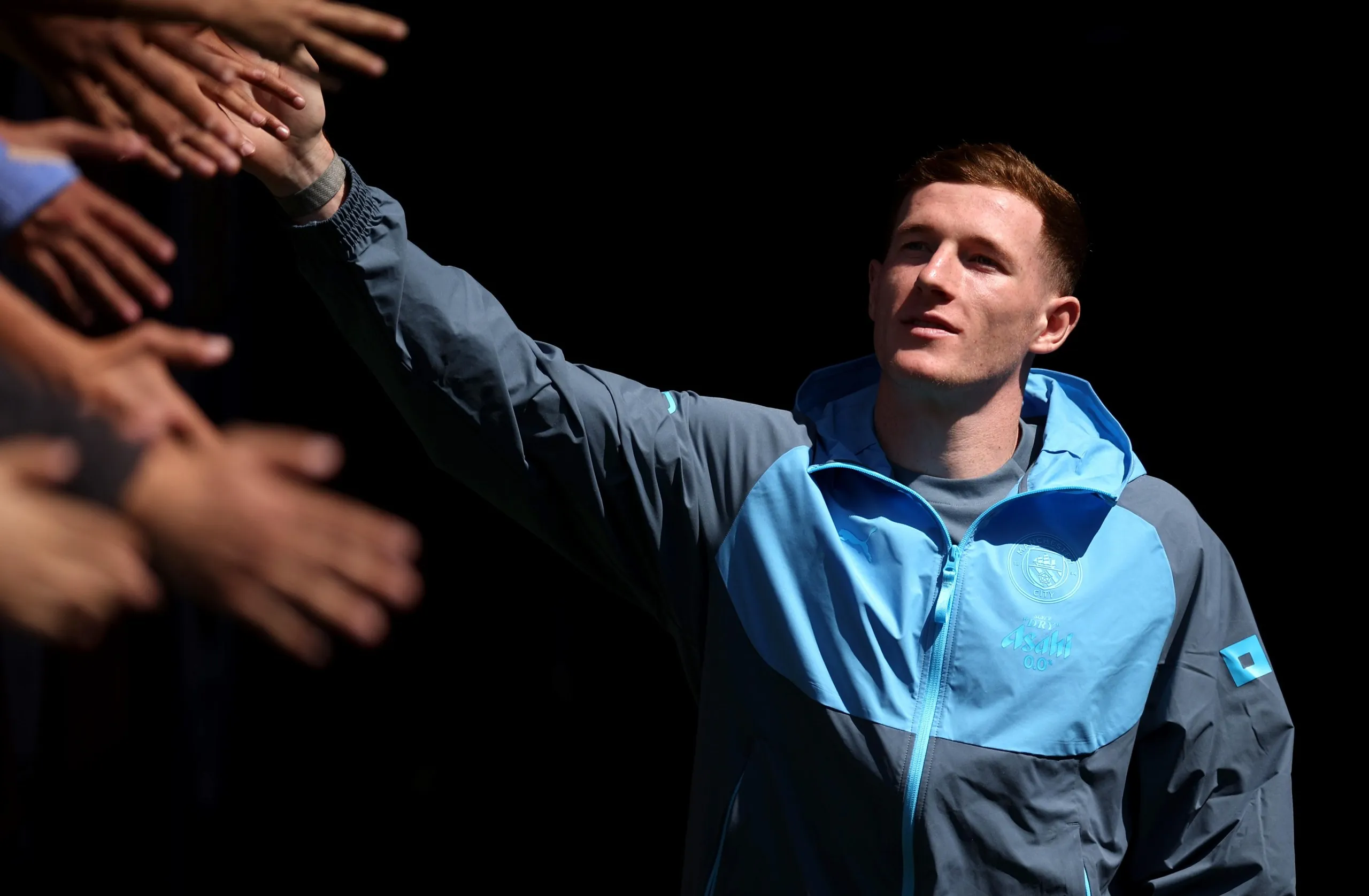 Elliot Anderson shakes hands with Manchester City supporters