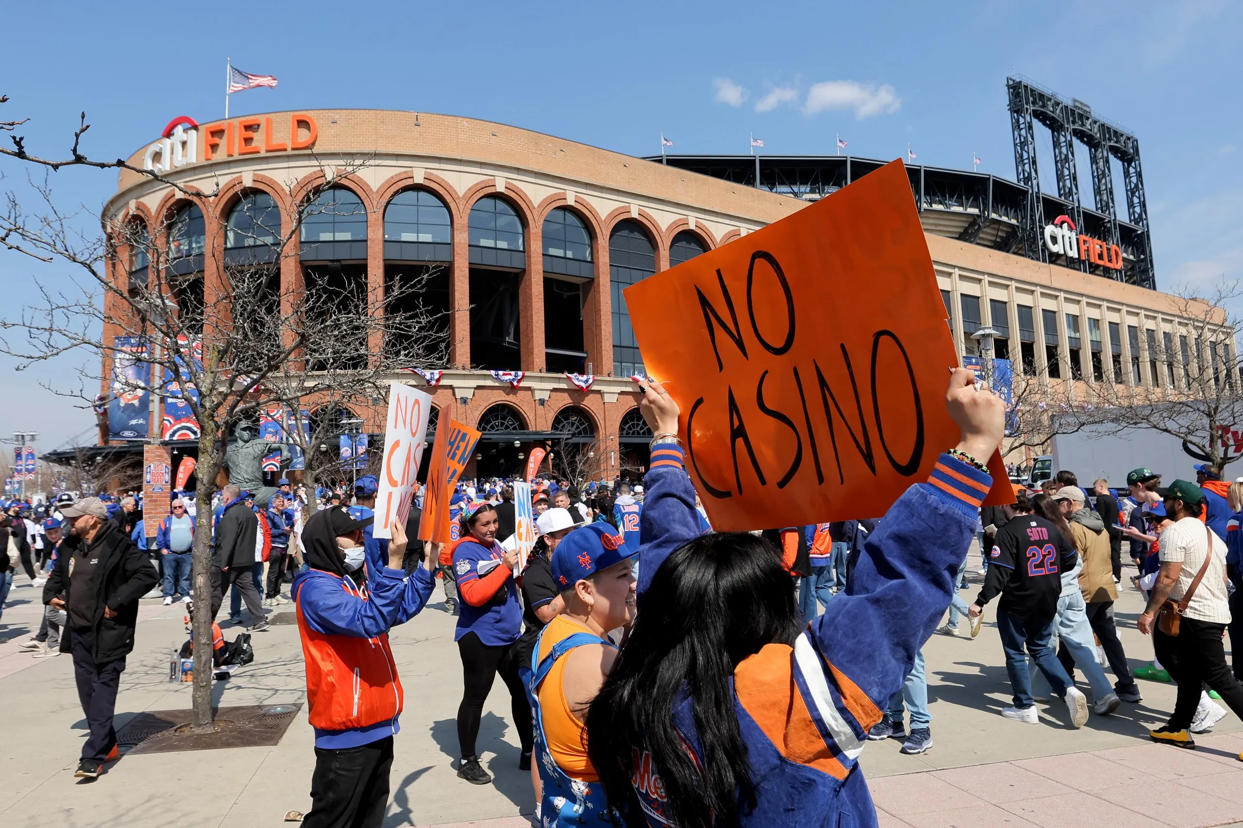 A group of people hold signs that say ‘No casino’
