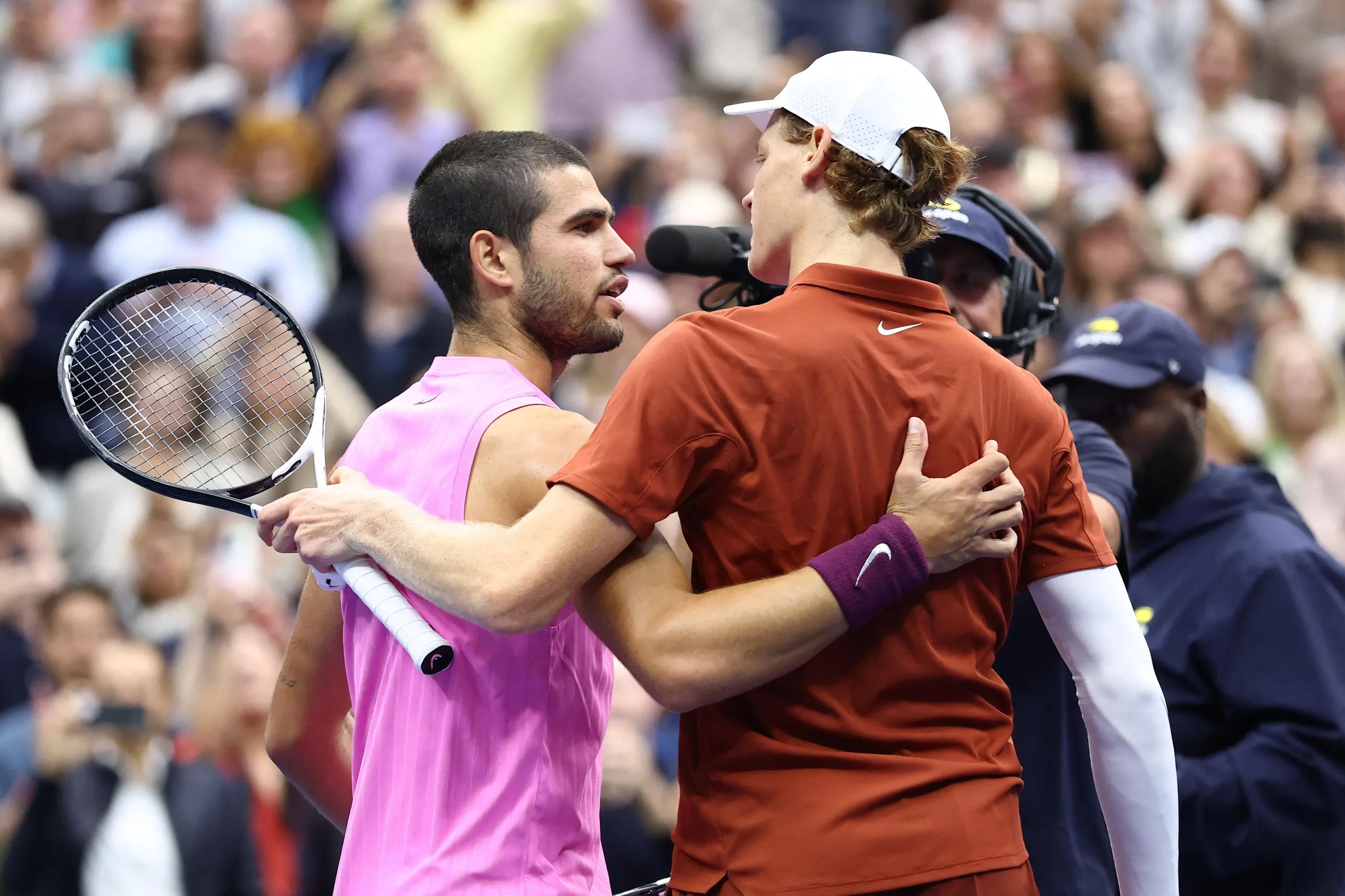 Carlos Alcaraz and Jannik Sinner greet each other at the net at the conclusion of their match