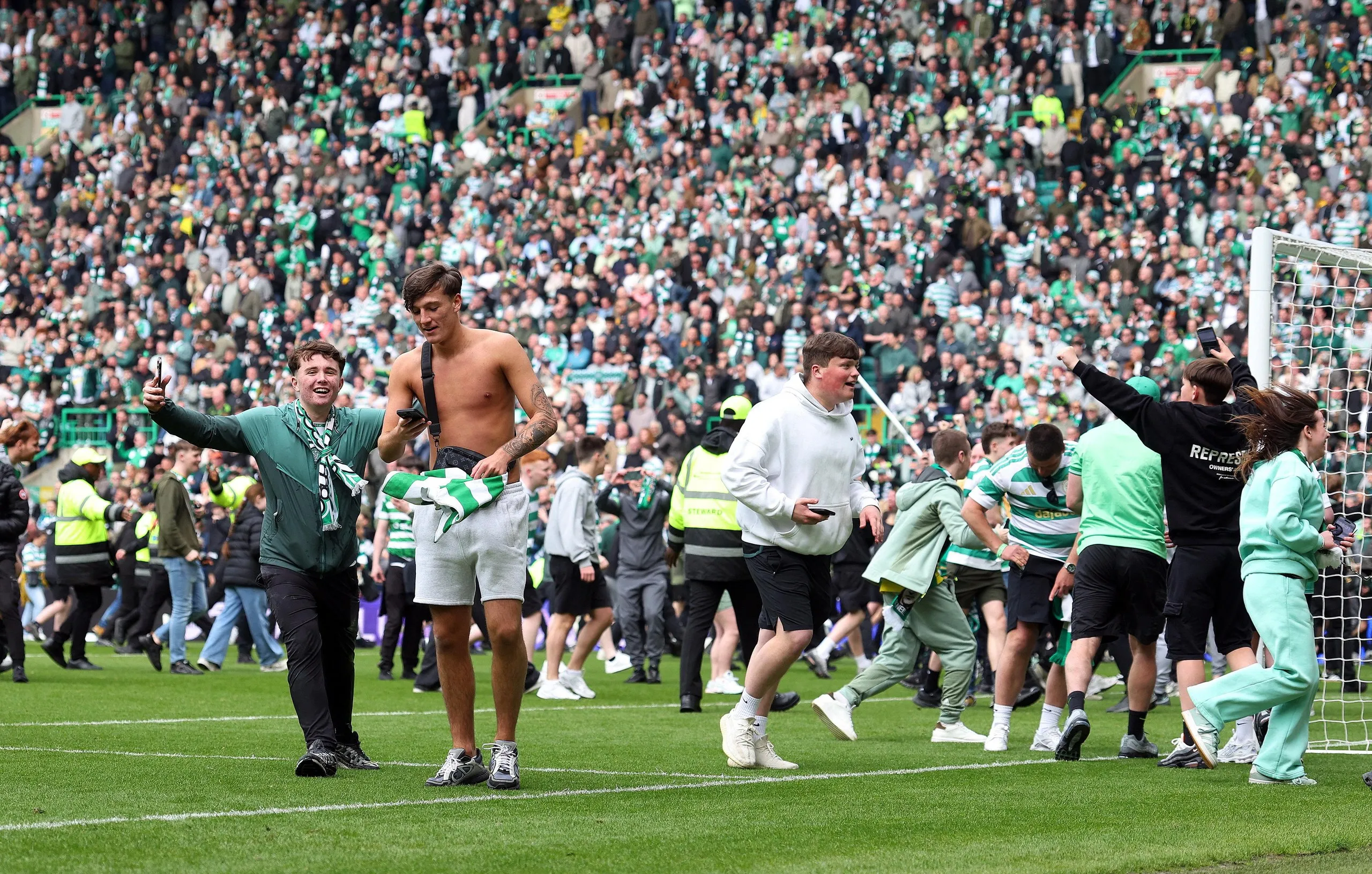 Celtic fans invade the pitch after Callum Osmand scores their third goal.