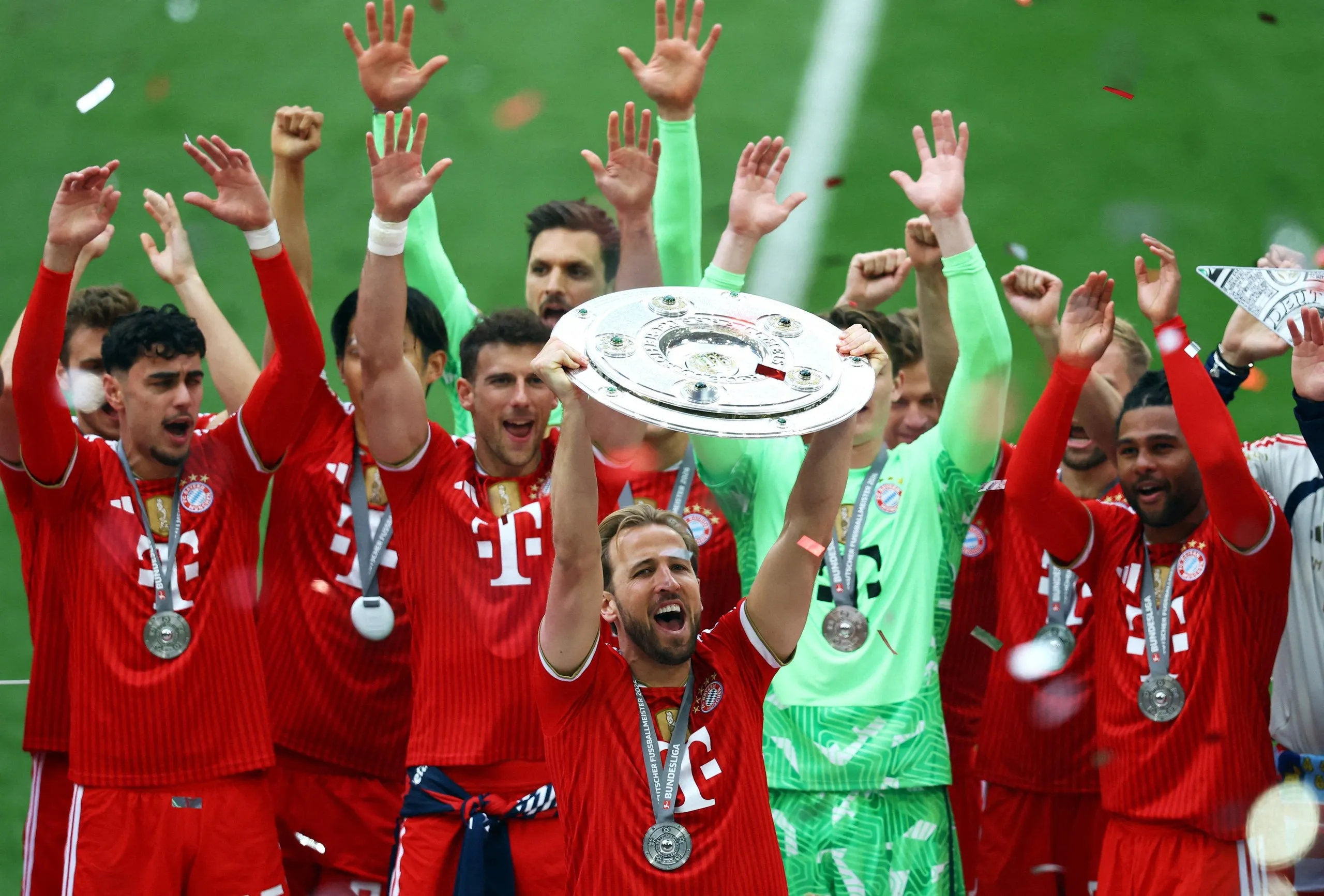 Harry Kane hoists the Bundesliga trophy with his Bayern Munich teammates