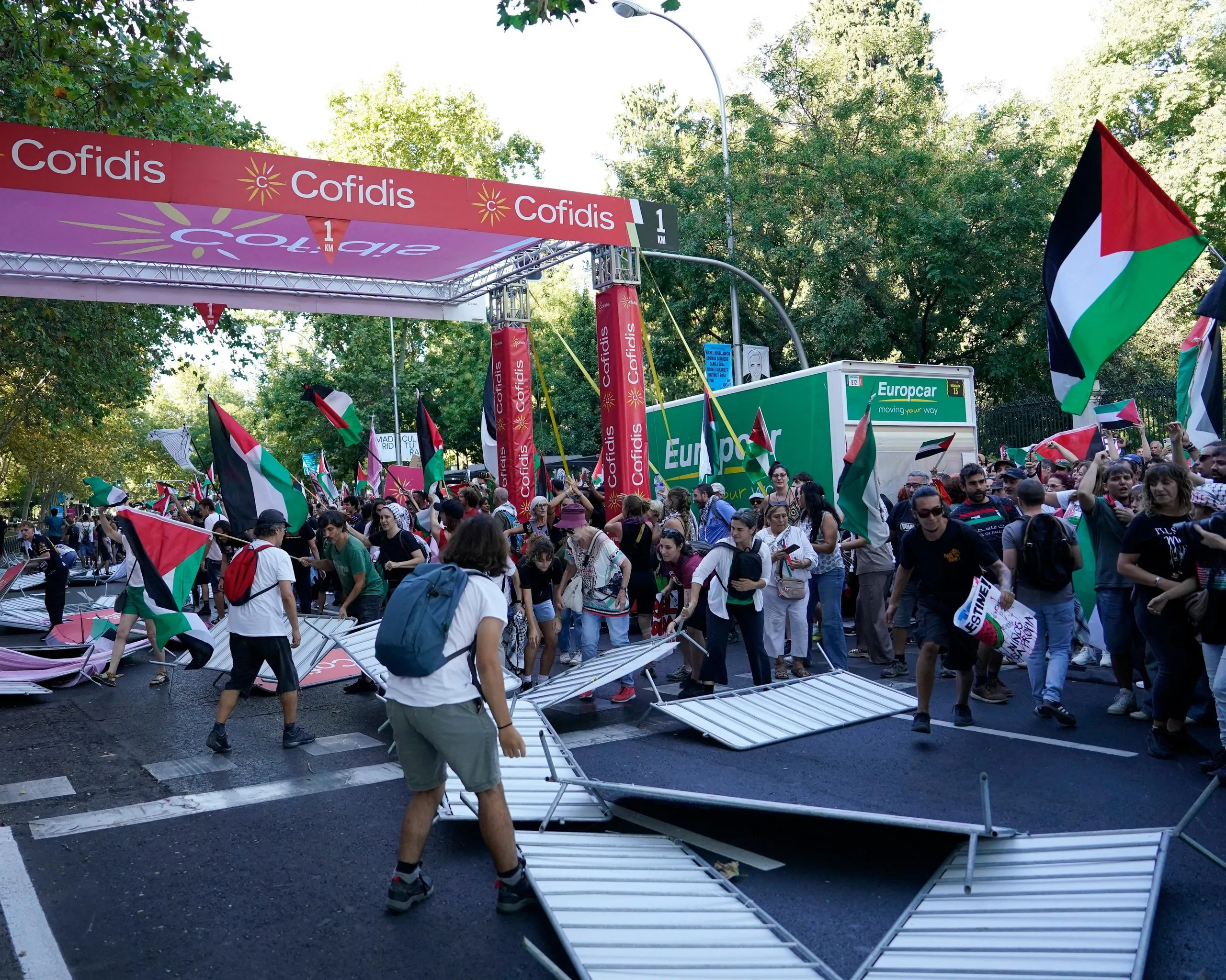 Barriers are smashed by pro Palestine protesters at the finish line of the final stage in Madrid.