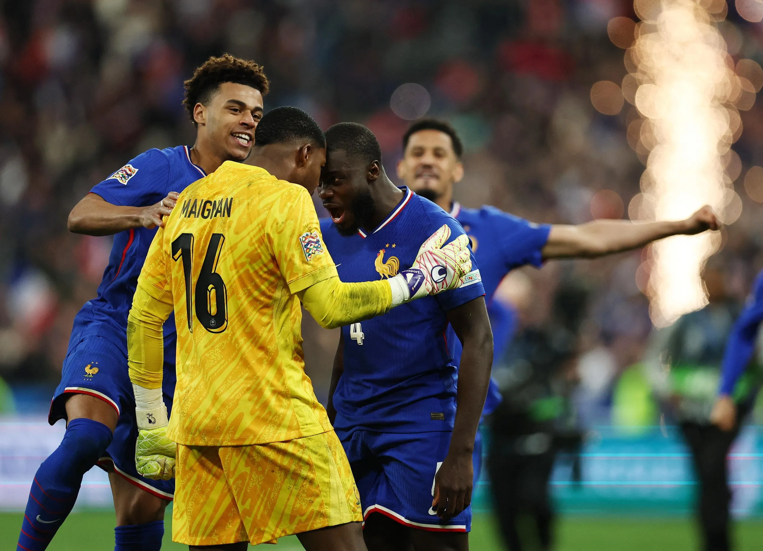 Dayot Upamecano celebrates with Mike Maignan after scoring the winning penalty for France