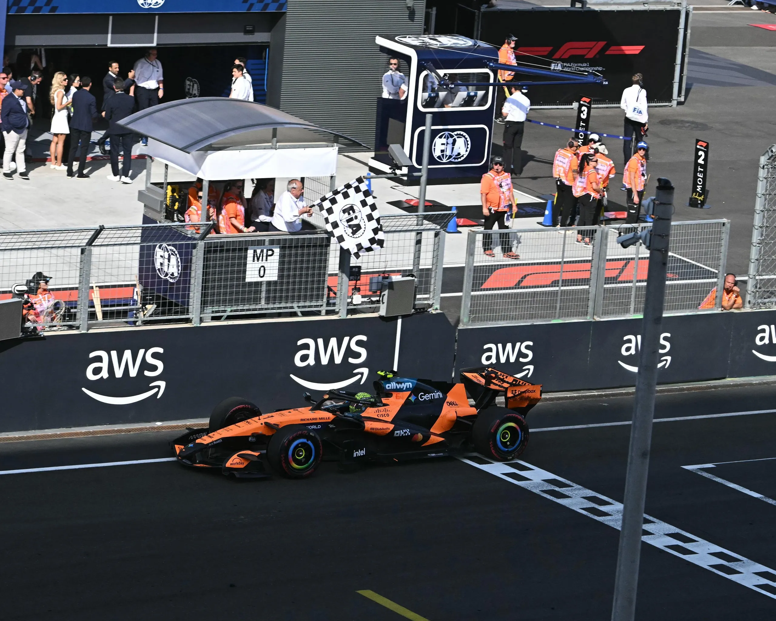 McLaren's British driver Lando Norris drives through the finish line to win.