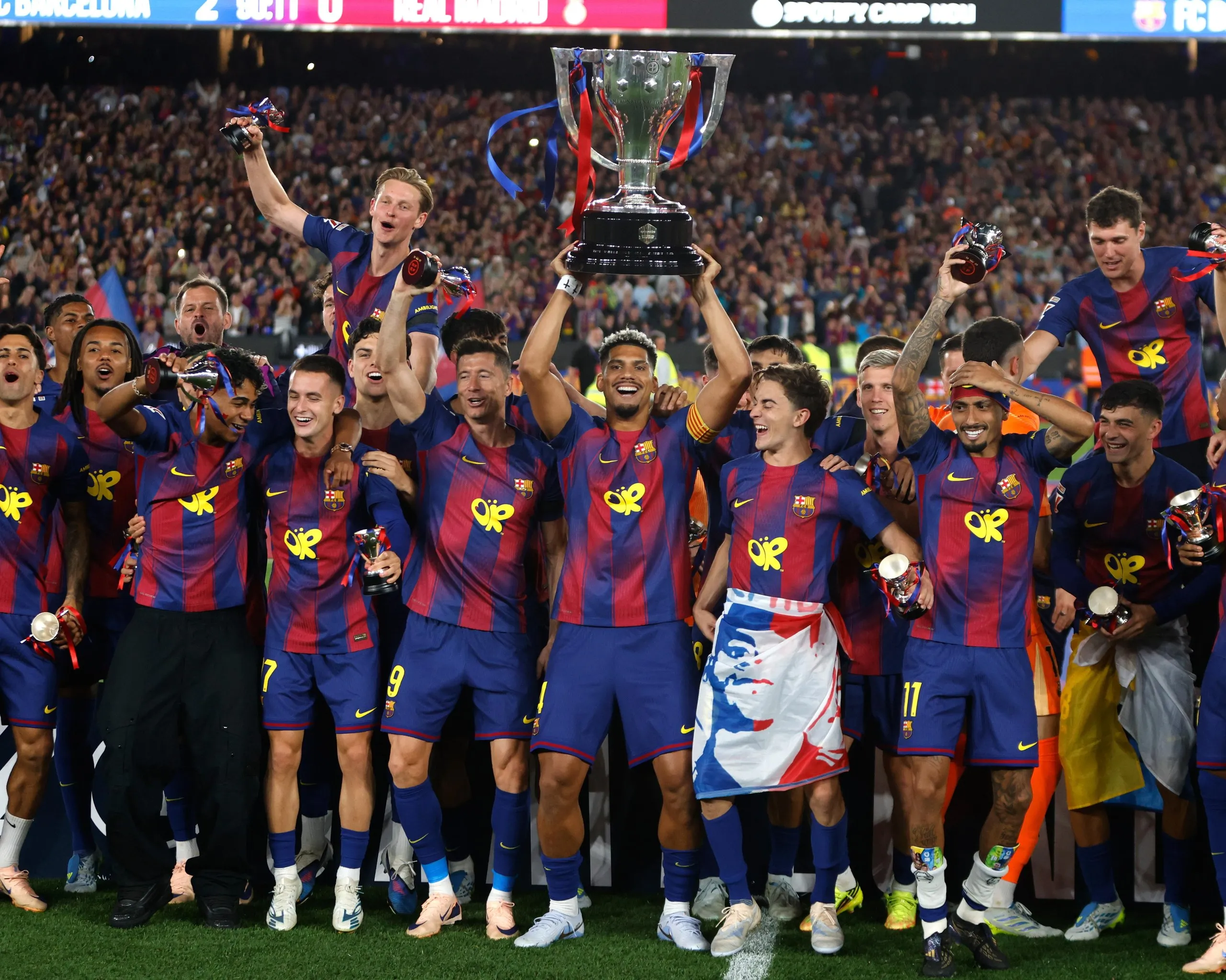 Barcelona’s squad lift the La Liga trophy after winning the league.