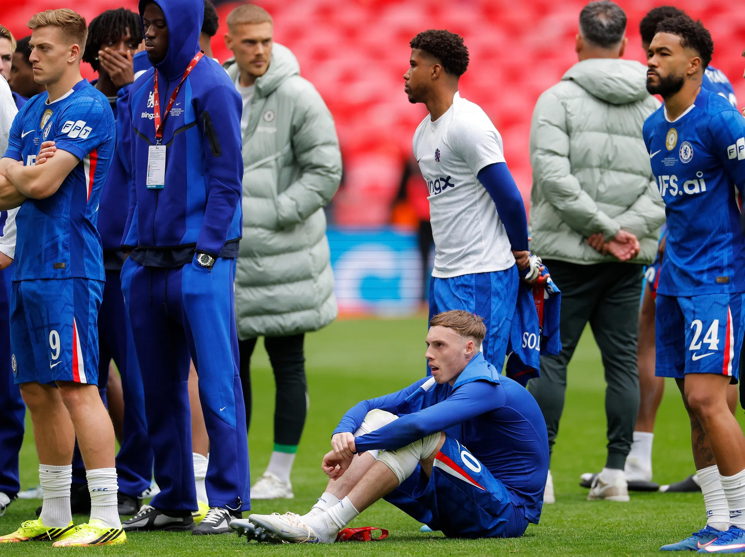 Cole Palmer (seated) and his Chelsea teammates look dejected after losing the Emirates FA Cup final.
