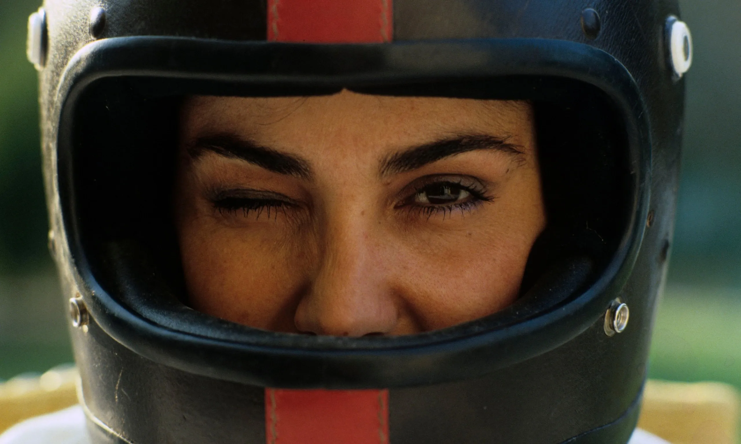 Michèle Mouton winks in a race helmet