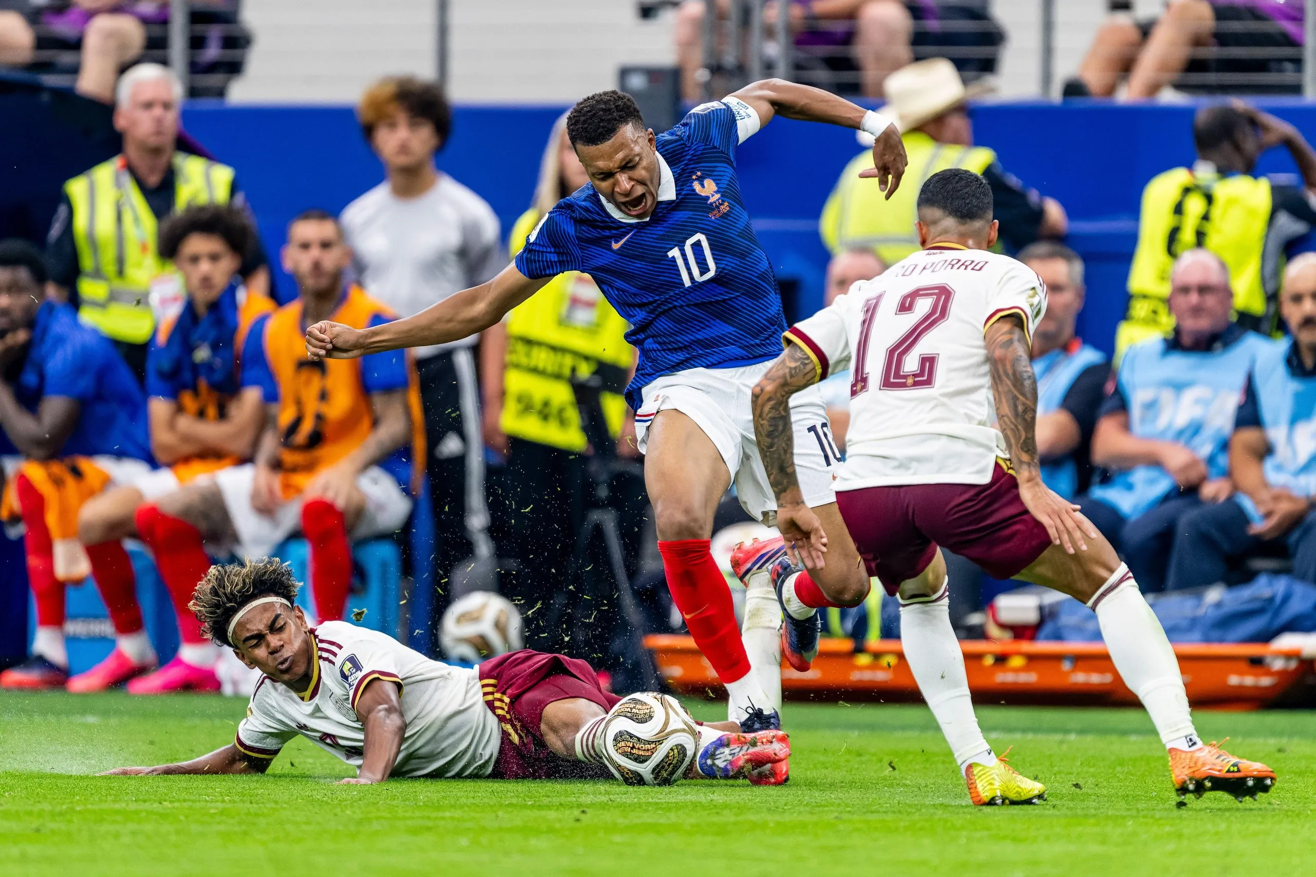 Kylian Mbappé is tackled by Lamine Yamal of Spain