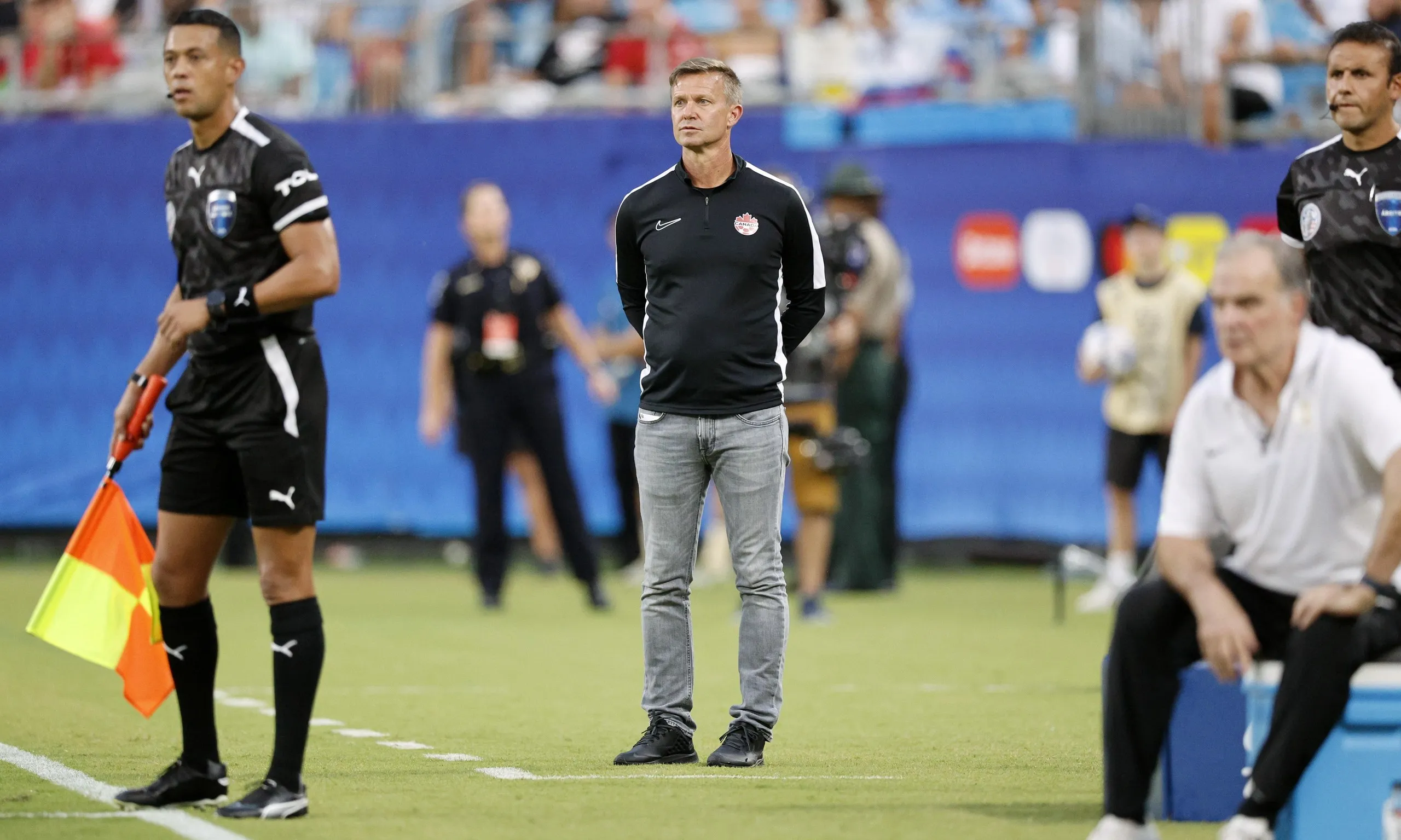 Canada head coach Jesse Marsch (centre) and Uruguay manager Marcelo Bielsa watch on from the sidelines