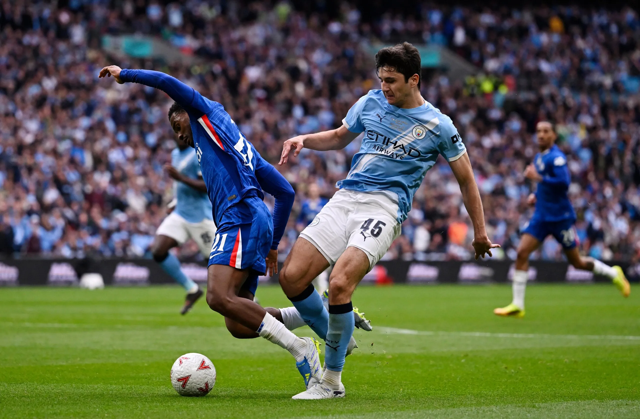 Chelsea's Jorrel Hato (left) goes down in the penalty area under pressure from Manchester City's Abdukodir Khusanov.
