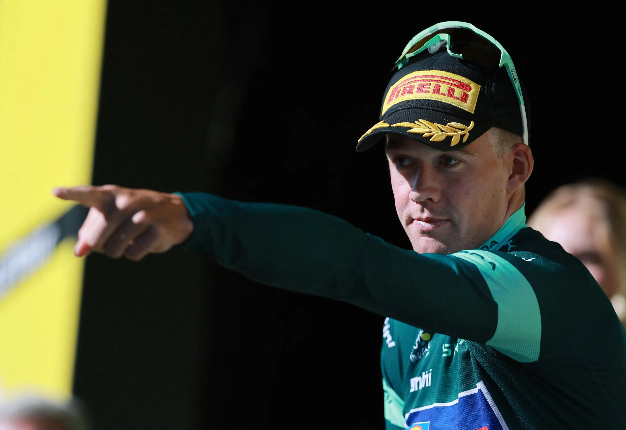Lidl - Trek's Mads Pedersen celebrates on the podium wearing the green jersey after stage 19.
