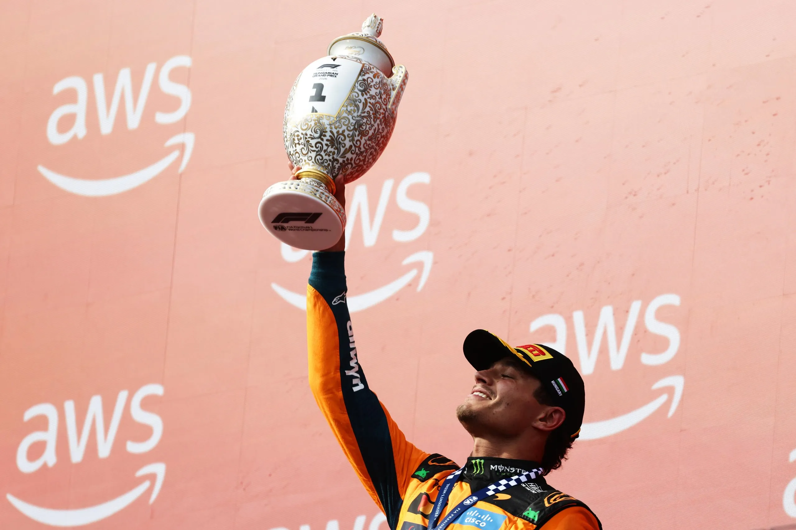 Norris lifts the trophy.