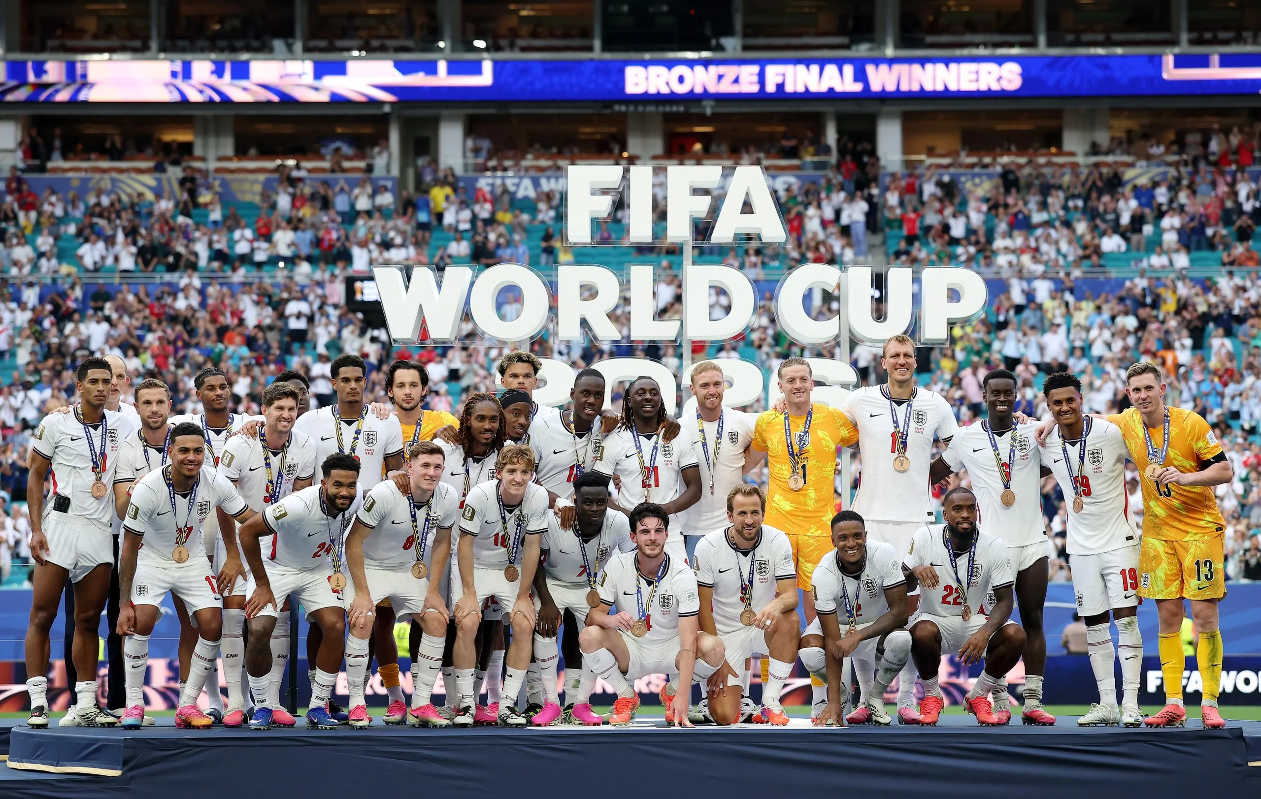 England players pose for a photograph after receiving their third place medals.